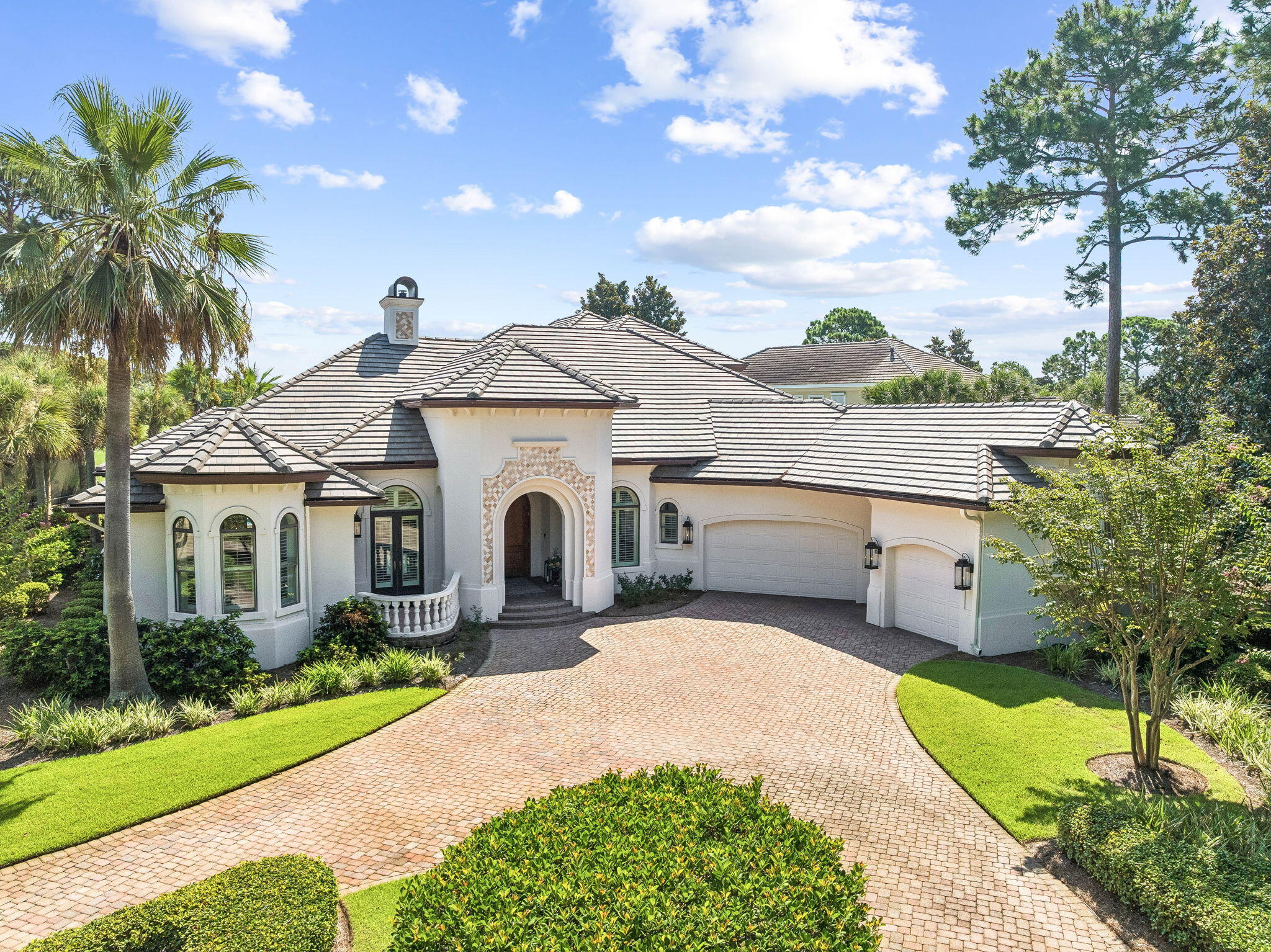 Set on a half-acre corner lot behind the gates of Burnt Pine, this spacious Sandestin residence offers a great layout, thoughtful updates and plenty of room to enjoy life both inside and out.

Inside, there is plenty of room to spread out. Multiple living and dining spaces give the home flexibility without making it feel disconnected. The kitchen features custom cabinetry, quartz countertops, stainless-steel appliances, a center island and a curved bar with seating. A beautiful tiled backsplash and statement range hood add to the space, while the open layout keeps the kitchen connected to the surrounding living and dining areas.

The outdoor space is where this home really shines. The screened pool area features an expansive pool, spa, fire and water feature, with plenty of space to lounge, entertain or just spend the day outside. The covered outdoor kitchen, added in 2022, includes a grill, refrigerator and sink, along with a wall-mounted TV. With the golf course and lake beyond the property, the setting feels private and peaceful without being completely tucked away.

The first-floor primary suite has direct access to the pool through large retractable glass doors. Custom painted walls add character to the space, while the primary bathroom features a unique curved-wall shower with Waterford etched glass and Taj Mahal quartzite countertops. The suite also includes a built-in safe for additional security. Upstairs, you'll find two additional bedrooms,including a dedicated bunk room with four bunks and a guest bedroom with its own ensuite bathroom. An additional full bathroom is conveniently located just off the bunk room. New hardwood flooring was installed throughout the second floor in 2026. Two balconies overlook the golf course and lake, giving you even more space to relax and enjoy the view.

The home offers an oversized driveway with plenty of room for multiple vehicles, along with an oversized three-car garage providing ample space for vehicles, golf carts, beach gear and storage. A new roof was installed in 2025, adding another meaningful update to the property.

Beyond the privacy and space this home offers, living in Burnt Pine puts you right in the middle of everything Sandestin has to offer. From the shops and restaurants at Grand Boulevard to beach access, championship golf courses, tennis, pickleball, the marina and the Village of Baytowne Wharf, there is always something to do for everyone. Whether it's spending the day at the beach, playing a round of golf, enjoying dinner or taking in one of the many events throughout the resort, it is all just a golf cart ride away.

Between the half-acre corner lot, expansive pool and outdoor living space, oversized driveway and three-car garage, and access to everything that makes Sandestin such a special place to live, this home offers the space, location and lifestyle to truly enjoy it all.