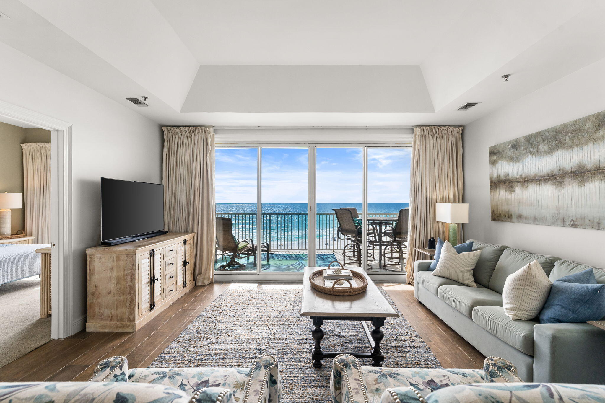 Exquisite sprawling single level residence in the exclusive gated community of The Empress at Seascape. This never-rented residence offers rare dual perspectives with two expansive balconies, one gulf-facing and one bay-facing, delivering sunrise-to-sunset views and coastal breezes. Beautifully decorated and sold fully furnished. Enter into your foyer where you have two sliding doors leading onto the back covered balcony overlooking the lake and amenities. Quaint sitting room with cozy furniture and a high top breakfast table perfect for teens or man cave or set up as your private office. Chefs delight kitchen with white cabinets, large pantry cabinet, raised breakfast bar opens to the dining room with seating for 6. The main living area  boasts gorgeous views of the sand and gulf. Your front covered balcony is accessed from the master bedroom and the family room. Two master suites capture stunning water views. The private 3rd bedroom offers two sets of bunk beds and plenty of room for entertaining the kiddos. The elevator opens to a shared foyer serving only two residences, creating a boutique, low-density feel. Additional highlights include a private heated & cooled storage closet, gated entry, community pool with hot tub, fitness center, and effortless beach access just steps away. Practically Gulf-front living - elevated and refined. Seller is offering a rare separate deeded garage space, call for details.