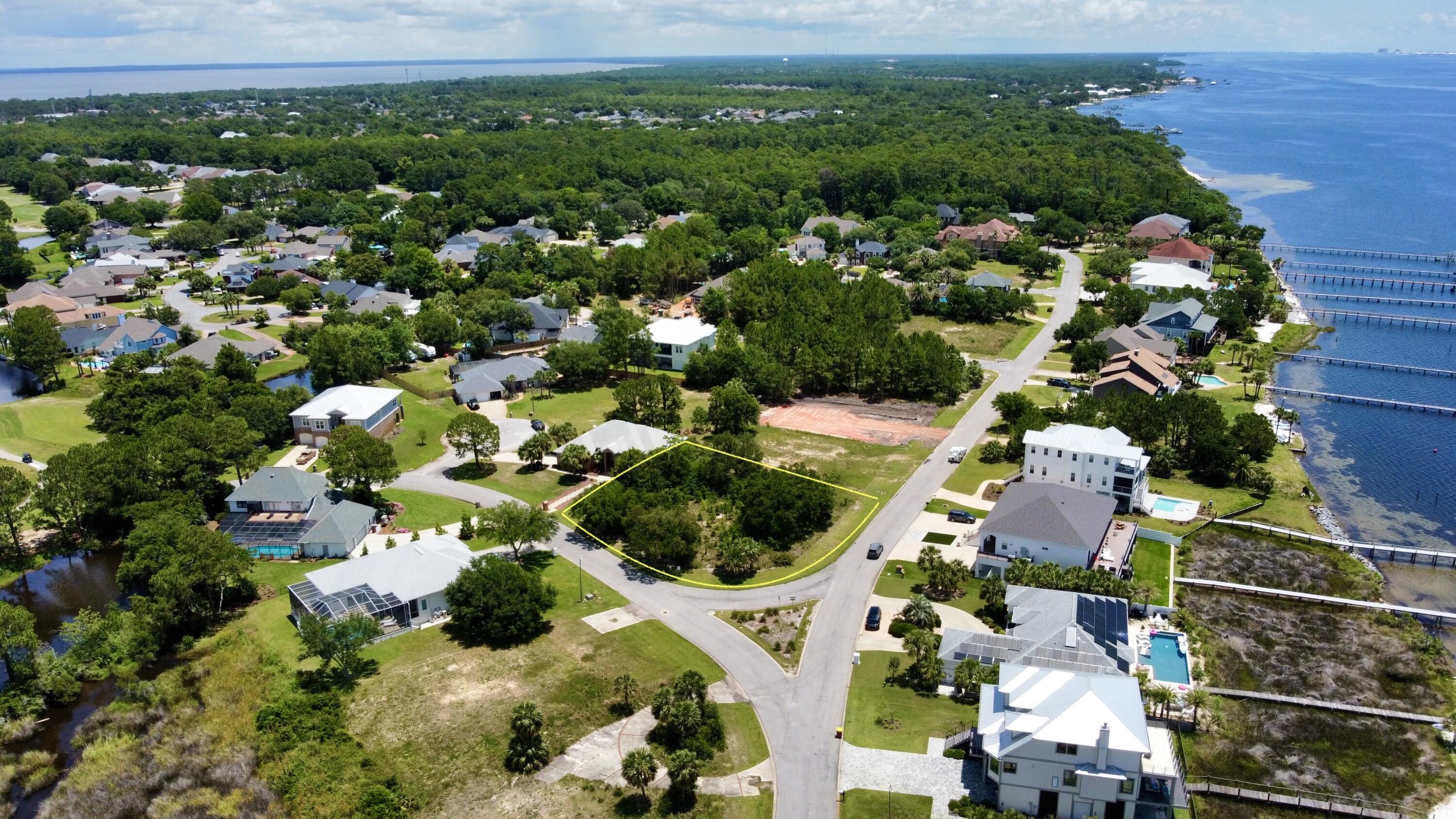 If you are looking for the perfect piece of property to build your dream home, this is it! This amazing property is located on a corner lot in the highly sought out Tiger Point Subdivision offering beautiful views of the Santa Rosa Sound and the Tiger Point Golf Course. Tiger Point is a golf cart friendly community so hop on your golf cart and head over to The Pointe where you can have a delicious meal over looking the golf course. The gorgeous white sand and emerald waters of Pensacola Beach are only 10 miles away. There are only a few vacant lots left, you don't want to miss out, especially on this one!