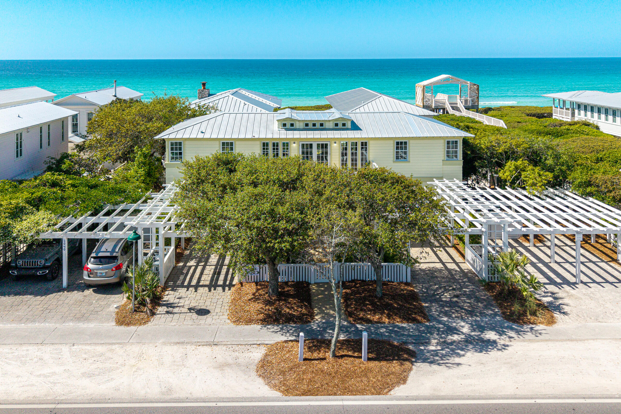 Experience the rare opportunity to own a home south of 30A in the world-renowned community of Seaside, Florida. This beautiful family home offered for the first time by the family who were the original builders and has been lovingly cared for and continuously updated since its construction. A coastal masterpiece with spectacular Gulf views designed for effortless entertaining. The second level features two spacious porches that seamlessly extend the living and dining areas to the outdoors. The heart of the home is the chef's kitchen, where a breakfast bar invites family or guests to gather while picnic lunches are prepped for a fun filled day at the beach. For quieter moments, retreat to the first-level media room for a movie night. The home's generous layout includes six bedrooms, highlighted by three luxurious king suites, and 6 full baths. Practical coastal living is built-in with a large storage area for all your beach gear and a refreshing outside shower to keep the emerald sand where it belongs. Located just steps from one of 8 private HOA beach accesses and featuring two private carports with a total of 4 parking spots. This is the ultimate Emerald Coast retreat to start making your family's beach adventures for many years to come. A few recent updates include new roof, impact rated windows and doors, new exterior siding, all decks and handrails replaced, painted inside and out, floors refinished, new window treatments, updated bath off kitchen, new landscaping.