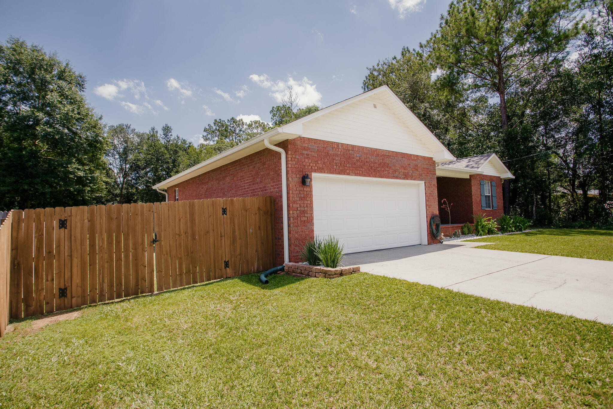 Attention Whiting Field!!!Welcome home to this charming and beautifully maintained 3 bedroom/2 bath split floor plan home.   Home is ideally situated in a peaceful country setting just about 30 minutes from the beautiful Gulf Coast beaches.  Conveniently located near Whiting Field , this property offers the tranquility of country living while keeping shopping and dining within easy reach.  Major improvements include:  A NEW ROOF IN 2022, HVAC IN 2019, WATER HEATER 2023, GUTTERS 2023 AND FRESHLY PAINTED INTERIOR 2026.   THE KITCHEN HAS ALSO BEEN REFRESHED WITH A WHIRLPOOL STOVE AND REFRIGERATOR IN 2026. WHILE THE WASHER/DRYER AND DISHWASHER WERE REPLACED IN 2022. An attic for extra storage.  Septic tank has been pumped and inspected in July 2026.
Outside is the beautiful flat yard which is perfect for a garden.  Plus, you'll appreciate the 8'  double gates to pull in a  boat or RV.  
This is an amazing all brick house which would make a wonderful home!! Don't miss your opportunity to own it!!!