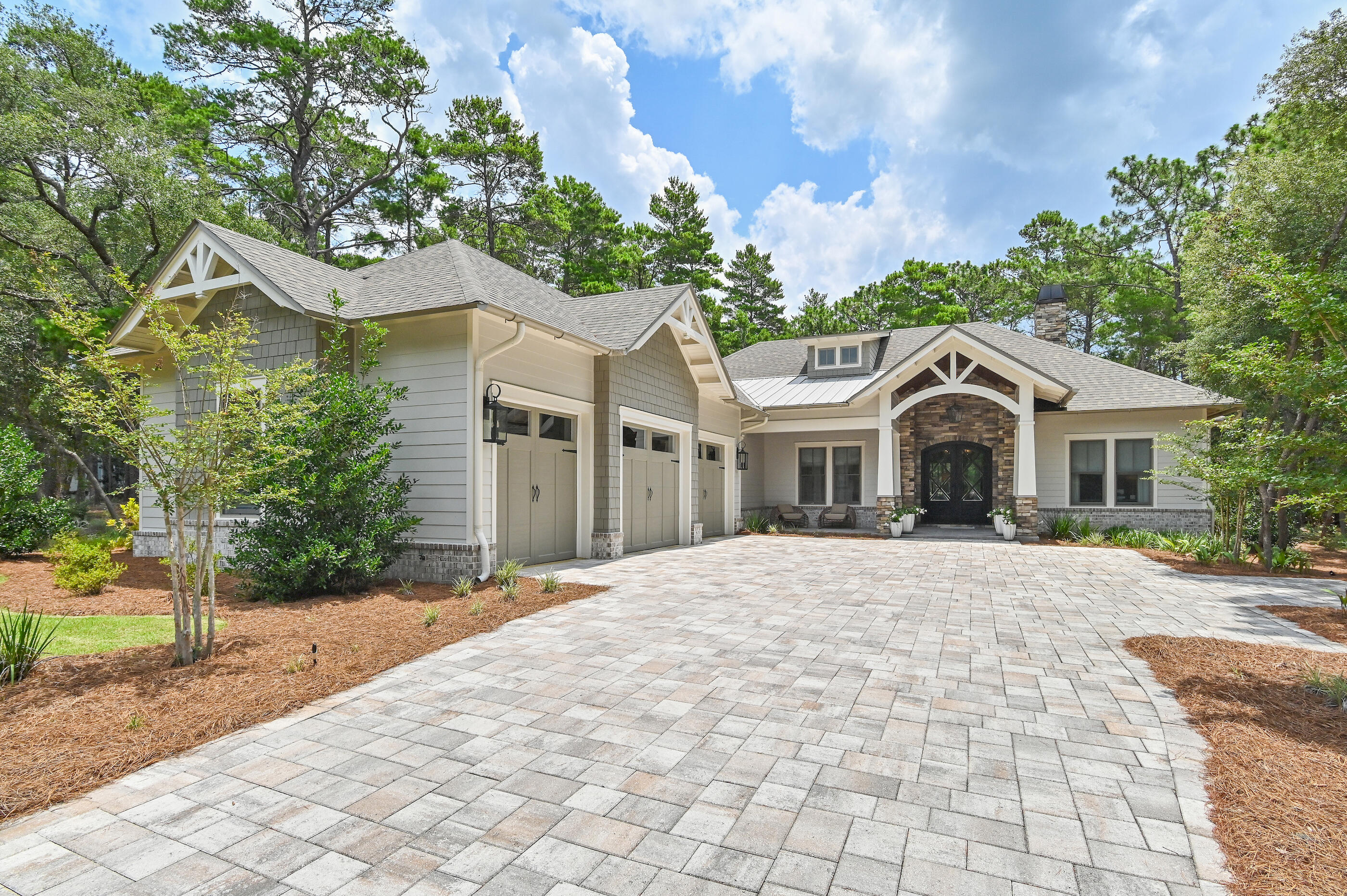 UNDER CONTRACT WITH KICK-OUT CLAUSE-ACCEPTING BACK UP OFFERS
Perfectly positioned on nearly one-half acre overlooking the 10th fairway of Shark's Tooth Golf Course, this custom residence, built in 2023 by a notable custom builder and architect, offers 2,937 square feet of beautifully appointed one-level living in the gated community of Wild Heron. 

Located on one of the community's most desirable streets, this 4-bedroom, 3.5-bath home enjoys peaceful golf course views, a fenced backyard with plenty of room to add a pool, quality 2x6 construction, and wheelchair accessibility throughout. 

Designed for comfortable everyday living and effortless entertaining, the open floor plan features 12-foot coffered ceilings accented by a custom designer mural in the living area, hardwood flooring throughout, a split-bedroom layout, and a versatile office or media room with workstations and a custom glass door. The owner's suite showcases vaulted ceilings with exposed wood trusses, a customized walk-in closet, private access to the screened porch, and a spa-inspired bath with dual vanities, a soaking tub, and a separate walk-in shower. 

The kitchen is both functional and inviting with a large quartz island, Butler's pantry, wet bar, Venetian plaster range hood, Bertazzoni stainless appliances, double ovens, and a six-burner gas cooktop. Expansive sliding glass doors open to the screened outdoor living area complete with a summer kitchen and fireplace,  Additional features include a solid mahogany Tiffany front door, Andersen windows, indoor and outdoor fireplaces, a tankless water heater, and a three-car garage with epoxy floors, dedicated outlets for an electric vehicle and golf cart, and abundant storage. Residents of Wild Heron enjoy exceptional amenities centered around Lake Powell, Florida's largest coastal dune lake. The community boathouse provides convenient storage for kayaks, paddle-boards, and other water toys, making it easy to launch from the community dock and explore Lake Powell all the way to the Gulf. Spend the day on the water or relax along the sugar-white sand and emerald waters bordering Camp Helen State Park. Additional amenities include a resort-style pool and hot tub, fitness center, community room, park, playground, firepit, marina with boat slips available for purchase or lease when available, and 24 miles of walking and biking trails. Optional memberships are available for Shark's Tooth Golf Club and the tennis center. Surrounded by a 732-acre coastal sanctuary, Wild Heron offers a peaceful setting just minutes from the beach, Pier Park, and the shopping and dining of Rosemary Beach and Alys Beach along Scenic Highway 30A.
Buyer to verify all data and dimensions. Measurements are approximate.