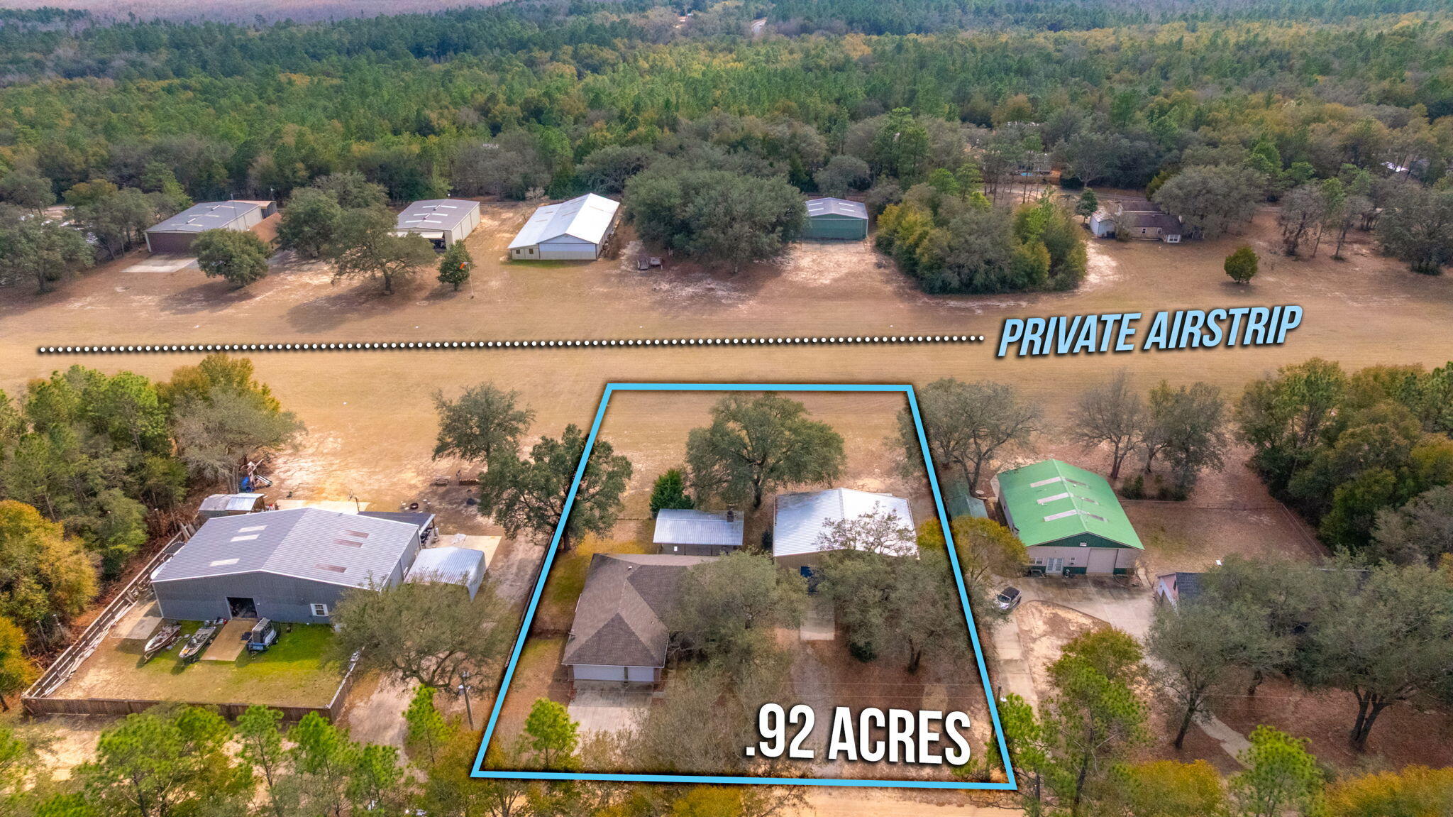 Welcome to 526 Tail Spin Drive in Holt, Florida--an aviation lover's dream with private runway access from your backyard. Taxi from your own hangar, featuring a bifold airplane door, and dedicated office space, straight to the skies. The property also offers a two-car attached garage and an outdoor living area with fireplace, perfect for gathering after a day of flying. A fenced dog run adds function and flexibility. This airpark home blends everyday comfort with the rare ability to live where you fly. Enjoy expansive views as aircraft arrive and depart, creating a backdrop unlike any traditional neighborhood. Designed for pilots, collectors, and those who crave open sky, this property delivers function and character in equal measure. Live where your runway meets your retreat. Fly home.