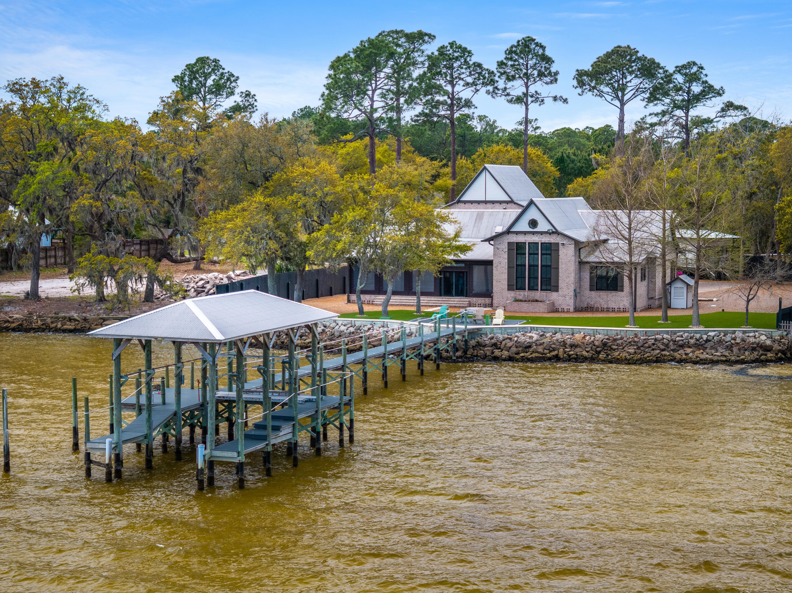Under Contract w Kickout - Accepting Backup Contracts - Bayfront estate on .82 acres with 140+ feet of waterfront in Santa Rosa Beach. Custom all-brick home built for durability featuring a metal roof, geothermal HVAC, private dock, and concrete seawall. Vaulted ceilings with exposed beams, expansive windows, and an open kitchen and living area capture sweeping bay views throughout. Primary suite overlooks the water with a spacious bath and private setting. Mature trees and wide-open grounds provide exceptional privacy and space to add a pool or guest house. Enjoy boating, fishing, and unforgettable sunsets from your backyard. Rare legacy waterfront opportunity with premium improvements already in place and room to create your own private coastal retreat in one of the area's most sought-after bayfront settings Positioned along the Choctawhatchee Bay, this .82-acre waterfront estate offers approximately 140+ feet of frontage--delivering a level of space, privacy, and infrastructure that is increasingly rare in Santa Rosa Beach.

This custom-built, all-brick residence was designed with long-term durability and efficiency in mind. Key structural and mechanical upgrades--including a metal roof and geothermal HVAC system--reflect the owner's commitment to quality, energy efficiency, and low long-term maintenance.

The property is already equipped for the waterfront lifestyle, featuring a private dock and concrete seawall, providing both protection and immediate access to boating, fishing, and paddleboarding.

Inside, vaulted ceilings with exposed beams define the main living space, while expansive windows frame sweeping bay views and fill the home with natural light. The open-concept kitchen and living area were intentionally designed for both everyday living and entertaining, always centered around the water.

The primary suite is positioned along the bay, offering a peaceful retreat with water views from both the bedroom and bath.

Owner-prioritized features and upgrades include:

Metal roof for durability and longevity
Geothermal HVAC system for energy efficiency
Concrete seawall providing shoreline protection
Private dock for direct water access
Solid all-brick construction
Vaulted ceilings with exposed beams
Expansive windows maximizing bay views
Open kitchen and living area designed for entertaining
Primary suite overlooking the water
Large driveway with ample guest parking
Mature trees creating natural privacy
Nearly .82-acre lot with room for pool, guest house, or expansion

Step outside and the scale of the property becomes even more apparent. The wide, usable lot offers flexibility rarely found on the bay--ideal for creating a true outdoor living environment or expanding the existing footprint.

With approximately 140+ feet of bay frontage, enjoy year-round sunsets and an unmatched waterfront lifestyle directly from your backyard.

Located just minutes from 30A, dining, and shopping, yet tucked away in a private, serene setting, this property offers both convenience and seclusion.

This is more than a home--it's a well-built, thoughtfully improved waterfront estate with the infrastructure already in place and the potential to become a true legacy property.