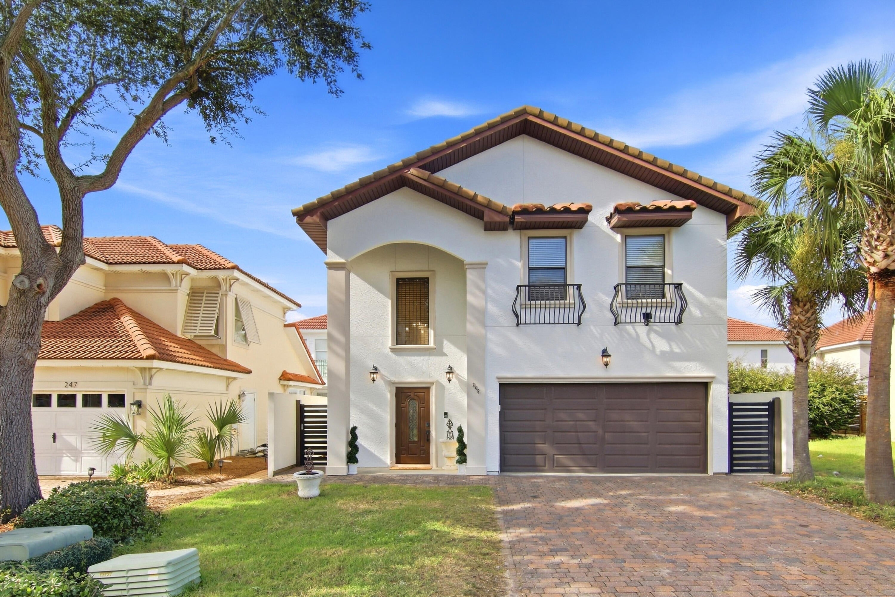 Experience the rare combination of sophisticated coastal design, extensive renovations, and private outdoor living in this exceptional residence located within a gated community in the heart of the Emerald Coast. Inspired by the timeless aesthetic of Alys Beach, this beautifully reimagined home has been thoughtfully transformed from the inside out, offering the feel of new construction with the established charm and setting of an existing neighborhood. From the dramatic approximately 28-foot-high foyer, the home's elevated design is immediately apparent. The entire residence has been freshly painted in Sherwin-Williams Alabaster White and features approximately 1,400 square feet of large-format limestone-style porcelain flooring, modern 8-inch baseboards, contemporary lighting, updated dimmable switches and outlets, and sophisticated champagne-gold hardware throughout.

The open-concept main living area is designed for comfortable everyday living and entertaining. The oversized gourmet kitchen serves as the centerpiece, featuring custom cabinetry, stainless steel appliances, a modern Wi-Fi-enabled refrigerator and range, white marble-inspired backsplash, pot filler, brushed-gold touchless faucet, upgraded hardware, modern downlighting, and abundant workspace. A statement dining chandelier and contemporary living-room lighting complete the home's refined aesthetic.

Upstairs, four spacious bedrooms provide privacy, including an expansive primary suite with a generous walk-in closet and an impressive approximately 200-square-foot ensuite bathroom. Extensively remodeled, the primary bath features a modern dual vanity with dedicated makeup station, contemporary mirrors and sconces, handmade-style Spanish shower tile, premium waterfall/rain shower system with integrated body jets and handheld wand, an updated jetted Jacuzzi tub with modern tile surround, limestone-style porcelain flooring, and coordinated contemporary fixtures. The guest bathroom has also been beautifully renovated with limestone-style flooring, a modern floating vanity, upgraded lighting, and a rain shower with handheld wand.

The outdoor living spaces elevate this property well beyond the typical renovation. Approximately 1,100 square feet of natural limestone hardscape, installed in 2023, creates a stunning foundation for entertaining. A custom approximately 150-foot, 6-foot-tall stucco privacy wall with custom slatted aluminum gates provides an exceptional level of privacy, while a custom outdoor shower and L-shaped stucco outdoor barbecue and grilling area create a true extension of the home's living space. New Zoysia sod and a smart 16-zone irrigation system complete the beautifully refreshed grounds.

Modern technology and convenience have been seamlessly integrated throughout the home, including a Ring security system with three exterior cameras, solar-powered camera capability, Wi-Fi-enabled keypad entry, smart lighting controls, Wi-Fi-enabled kitchen appliances, updated LED lighting, and a Level 2 Tesla EV charger in the garage. Two slim-profile Carrier A/C condenser units provide an additional modern upgrade.

Beyond the residence, enjoy the amenities of this private gated community, including a community pool, clubhouse, and gazebo. Ideally positioned near Highway 98, this home places you minutes from Destin Commons, Silver Sands Premium Outlets, exceptional dining and entertainment, championship golf, and the sugar-white beaches and emerald waters of the Emerald Coast.

Beautifully renovated, thoughtfully designed, and exceptionally private, this is a thoughtfully reimagined coastal residence where sophisticated design, modern functionality, privacy, and exceptional outdoor living come together.