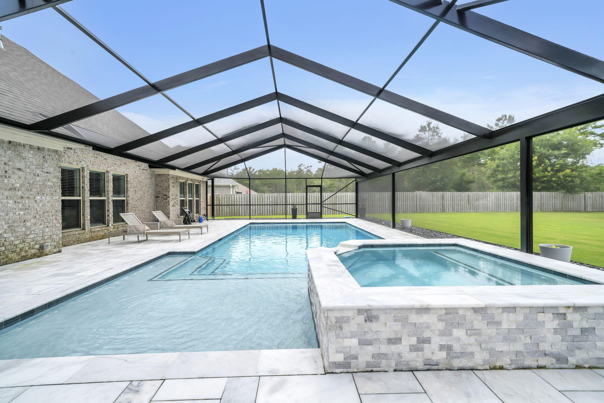 If living like you're on a permanent vacation sounds appealing, this is the home you've been waiting for. Located in the highly sought-after Buxton's Mill neighborhood of beautiful Hammock Bay, this exceptional property offers the perfect blend of luxury, comfort, and community. Situated on a spacious lot with an expansive backyard, this home is designed for both relaxation and entertaining. Whether you're hosting family gatherings, enjoying outdoor activities, or simply unwinding at the end of the day, the stunning resort-style pool and hot tub create a private oasis that can be enjoyed year-round. Inside, you'll find a beautiful two-story home featuring an open-concept layout, luxury vinyl plank flooring throughout, and a cozy gas fireplace perfect for cooler Florida evenings. The thoughtfully designed split floor plan offers generously sized bedrooms, a massive walk-in pantry, custom cabinetry in the laundry room, and numerous upgrades throughout. The chef-inspired kitchen is highlighted by elegant granite countertops, while additional features include a whole-home generator, tankless water heater, and a gas stub on the back porch--ready for the outdoor kitchen of your dreams. Beyond the home, Hammock Bay offers an unparalleled lifestyle with a vibrant, close-knit community, year-round neighborhood events, and endless opportunities for recreation and family fun. Residents also enjoy convenient access to some of the area's most beautiful beaches, exceptional dining, shopping, and top-rated schools. This is more than just a home--it's your own private retreat. Offering the perfect combination of space, comfort, and resort-style amenities, this remarkable property is ideal for both everyday living and unforgettable entertaining. Don't miss the opportunity to make it yours.