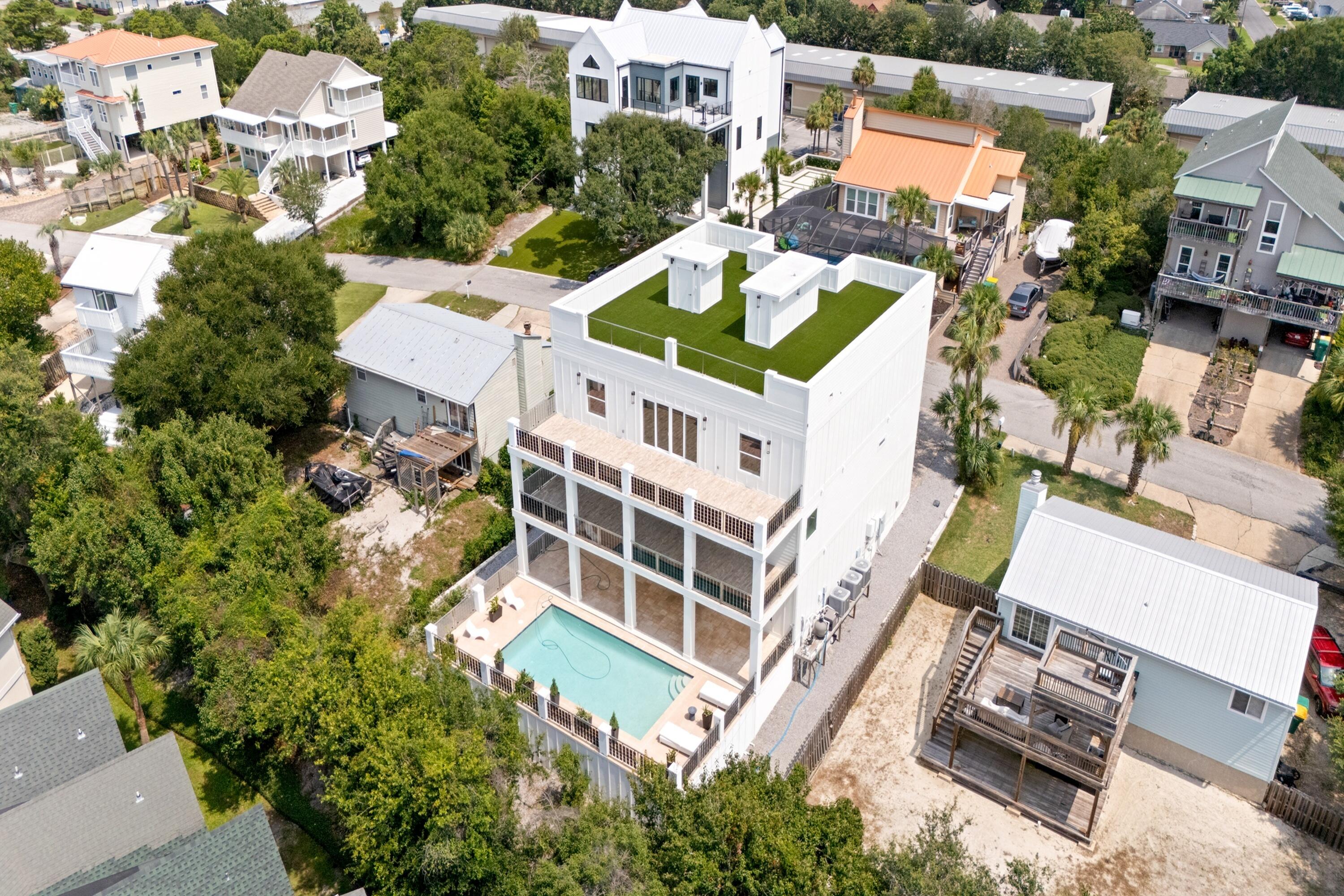 Space for all your cars and toys while walking to restaurants, the harbor, shops, and entertainment. This no HOA urban entertainment compound and executive retreat is a true car and boat enthusiast dream. Offering unheard of value as a portfolio builder, this fully renovated 5800 square foot 7 bedroom 6.5 bathroom estate features ultra fortified ICF construction. Investors will immediately recognize the potential for accelerated appreciation and massive cash generation, as this is easily the best value per square foot in Destin hands down.

Property and Lifestyle Highlights:

Massive Parking: Tandem 7 car garage plus paved driveway room for an RV or boat. Executive airport nearby for easy corporate travel.

Rooftop Oasis: A 2000 square foot rooftop lawn with artificial turf offers 360 degree views. Watch parades and all city firework shows at once from the highest point in town.

Resort Amenities: 4 entertainment balconies overlook the private saltwater pool, actively heated by custom solar panels infused directly into the glass balcony railings. Includes mature fruit trees.

Interior Luxury: High end Thermador and Miele gourmet kitchen, first floor kitchenette, wine and book library, and custom wood closets. Dual masters provide incredible layout flexibility.

Unbeatable Location: Walk directly to McGuires, HarborWalk, Crab Island access, and nightlife. Near boat launches and a quick jaunt straight to the Gulf.