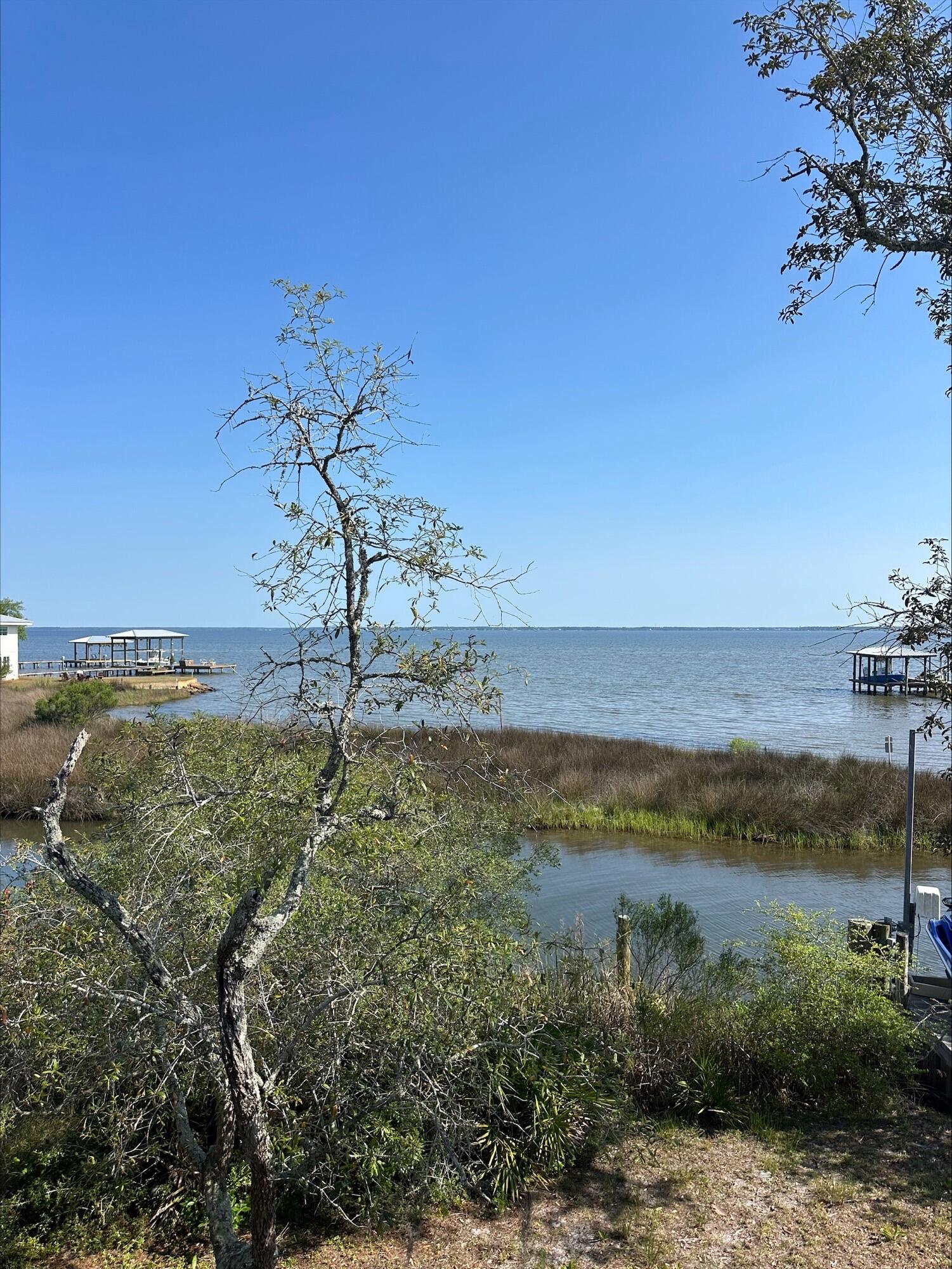 Canal Front Lot with wide open Bay views. This lot offers the best of both worlds. Very few lots in the area offer the protection of being able to dock your boat in the protected waters of the canal but still have the wide-open views over the sawgrass of the Bay.