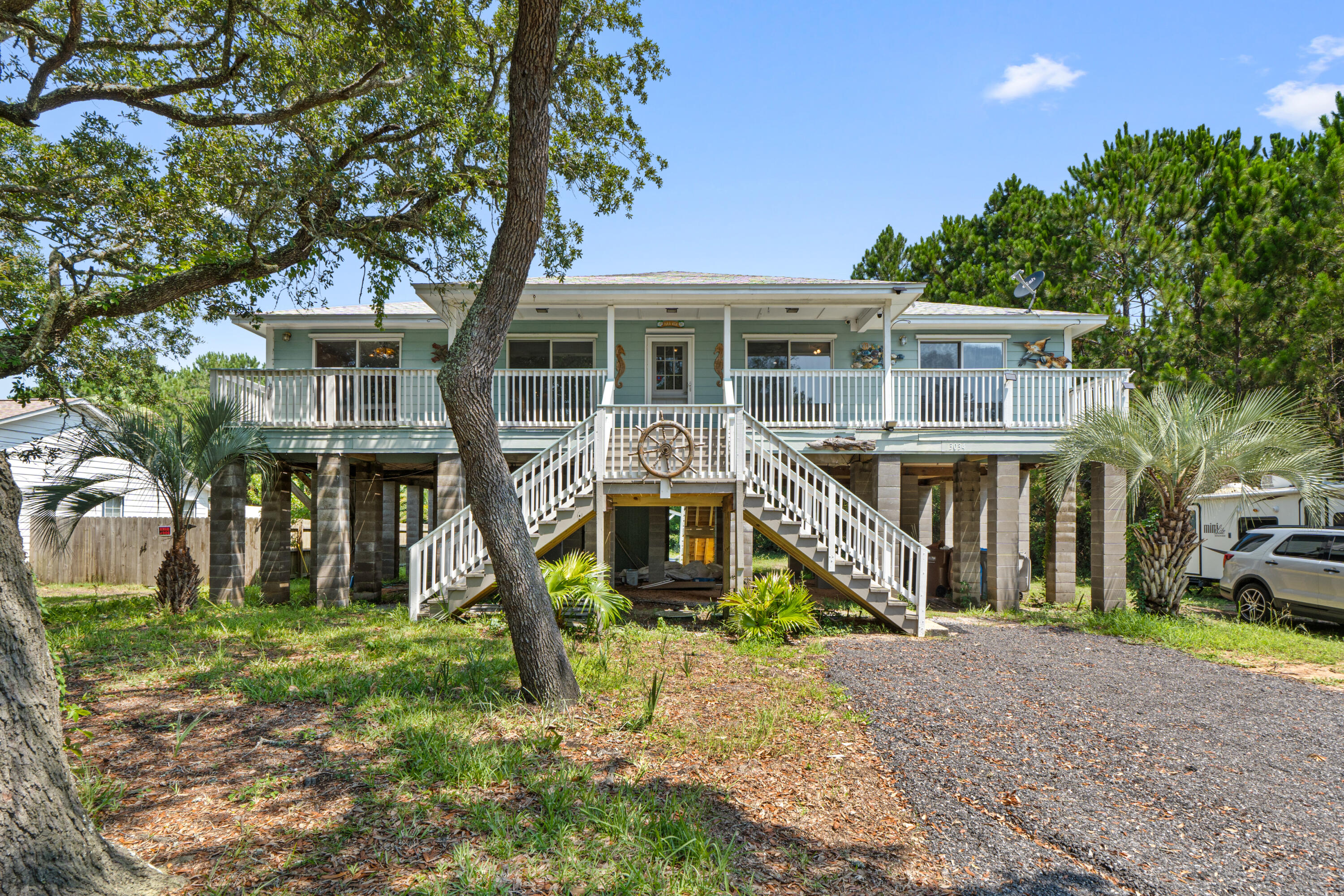 Exceptional Gulf Breeze Location with Water Views & Unlimited Potential!
Nestled on desirable Bay Street in Gulf Breeze, surrounded by stunning waterfront and luxury homes, this elevated 4-bedroom, 2-bath residence offers a rare opportunity to enjoy one of the area's most sought-after neighborhoods at an attainable price point. Take advantage of the nearby public boat launch just an easy walk away, making it simple to embrace the coastal lifestyle. The home features durable HardiePlank siding, an expansive 27-foot front porch perfect for relaxing and enjoying the neighborhood atmosphere. The kitchen, dining, and living areas flow seamlessly together, creating a spacious gathering space.
Elevated on pilings, the home offers a substantial unfinished lower level ready for a new owner's vision. Whether you dream of additional storage, recreational space, hobby areas, or future improvements, the possibilities are endless. A ground-level workshop measuring approximately 26' x 13.9' is already equipped with electricity and provides excellent space for projects, tools, or boating gear. While the home is ready for cosmetic updates, including flooring and interior paint, it presents an outstanding value-add opportunity in a neighborhood where location is everything. Create your own style and build equity while enjoying proximity to the water, boating access, beaches, shopping, and all that Gulf Breeze has to offer. Don't miss this chance to make this property your own.