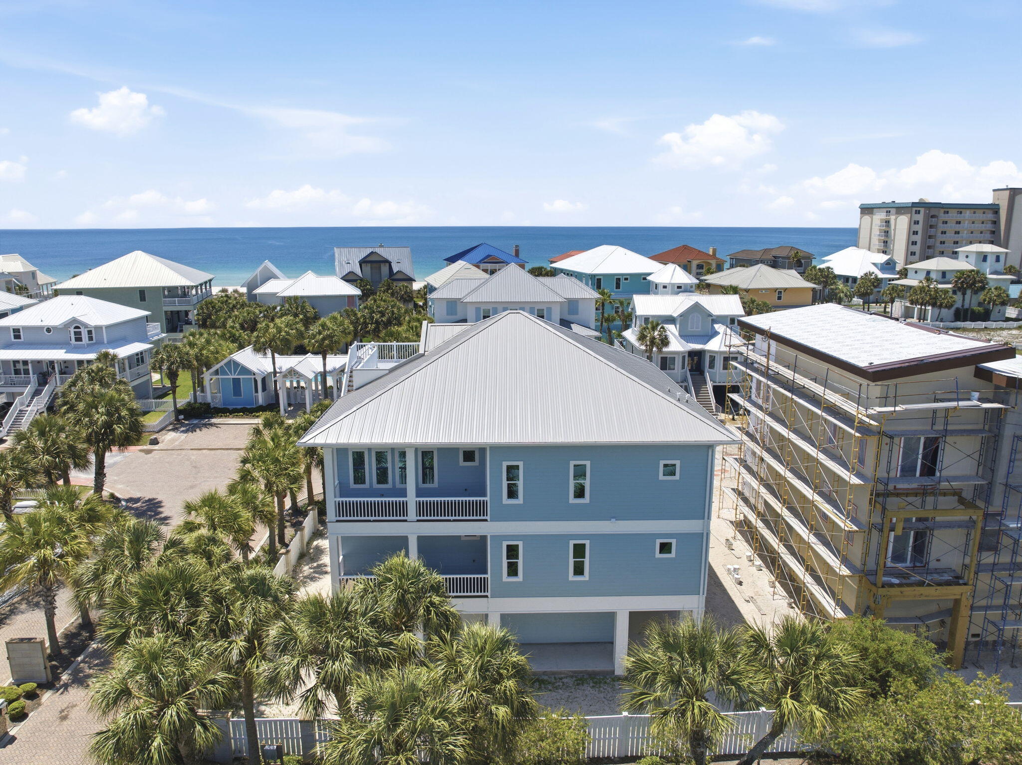 Newly completed in 2026, this stunning corner-lot beach home offers the rare opportunity to be the first to own & enjoy this beautifully crafted coastal residence in the serene Parasol community. Designed to embrace the beauty of Gulf Coast living, the home features multiple porches along with a spectacular top lookout deck showcasing breathtaking views of the Gulf & Intracoastal Waterway. From unforgettable sunsets to coastal breezes, every space was created to enhance a coastal lifestyle. Private elevator provides convenient access to each level. Each bedroom offers private exterior access. Main floor offers a spacious junior primary suite complete with an elegant en suite bath. Two additional large guest bedrooms are also located on this level along with a versatile lounge space featuring a wet bar sink & beverage cooler. Perfect as a media room, play area, office, game room, or additional entertaining area for guests, this flexible space adds incredible versatility to the layout. Top floor is dedicated to the main living spaces where soaring ceilings & natural light create a bright, inviting atmosphere. Living room features a beautiful electric fireplace that adds warmth & character to the coastal design. Kitchen was built for gathering with a stunning custom island offering generous seating, a gas range & seamless flow into the dining & living areas. Primary suite on the top level serves as a private retreat with a spa-inspired en suite bath featuring double vanities, a soaking tub, oversized tiled shower & two large walk-in closets. Multiple porches extend the living spaces outdoors with 1850sf of covered porches for the ultimate indoor-outdoor coastal experience, & its already equipped with gas hookup for future outdoor kitchen, making outdoor entertaining effortless. Parasol owners enjoy approximately 900' of private Gulf-front beach access along with a community pool located just a short distance from the home. Your NEW beach home is calling!