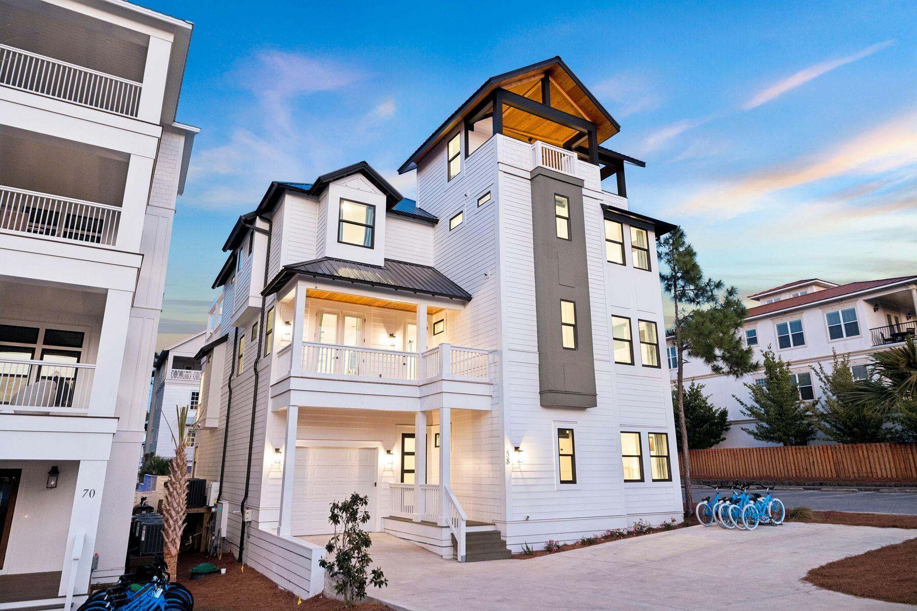 Recently built and thoughtfully designed for both luxury and performance, this exceptional Seagrove Beach retreat offers a rare combination of proven rental success--with over $300,000 of rental income on the books for 2026--elevated finishes, and resort-style amenities, all just a short stroll to one of 30A's most desirable beach accesses. Spanning over 5,400 square feet, the home features six bedrooms, each with en-suite baths, comfortably accommodating up to 26 guests. A first-floor primary suite option with a private en-suite bath adds flexibility and convenience, ideal for owners or guests seeking main-level living. Offered fully furnished and turnkey, the property boasts a proven rental history and a layout intentionally designed to maximize both guest experience and revenue. The first level opens into a bright, open-concept living and kitchen space equipped for large groups, complete with double appliances including two refrigerators, two dishwashers, double ovens, and a standalone ice maker. This space flows seamlessly to the outdoor living area, where a zero-entry lagoon-style pool, separate hot tub, outdoor kitchen, putting green, and fire pit create a private backyard setting ideal for entertaining. The second floor is centered around recreation and gathering, featuring an expansive game room with pool table, shuffleboard, poker table, and a full bar with beverage fridge. A dedicated theater room offers an immersive viewing experience, while a convenient half bath serves the main living area. Two well-appointed guest suites, each with en-suite bathrooms--one with a private balcony--complete the level, along with a covered porch overlooking the pool. On the third floor, additional guest accommodations include two king suites and a large bunk room designed to host multiple families. Offering an array of sleeping options, the bunk room has an ensuite bathroom with a triple vanity and two separate showers to fully accommodate all guests. A spacious secondary living area anchors the floor, complete with a coffee and beverage bar, and opens to a large covered deck with vaulted ceilings--an ideal setting for relaxed mornings or evening gatherings overlooking the surrounding landscape. Crowning the home, the fourth-floor rooftop deck captures sweeping Gulf views and unforgettable sunsets, offering a true vantage point rarely found this close to the beach. Distinct indoor and outdoor living areas provide ample space for guests to gather or spread out, while premium features such as a theater room, wood-clad porch ceilings, custom wall detailing in each guest suite, EV charger, and an included six-seater golf cart further enhance both lifestyle and rental appeal. Located in a non-HOA setting just steps from the Santa Clara beach access--complete with parking, restrooms, lifeguards, and a ramped walkway--this property combines convenience with one of the most sought-after stretches of coastline along 30A. Its proximity to Seaside, WaterColor, and Seagrove's dining and retail destinations, including Greenway Station, makes it an ideal choice for both investors and those seeking a high-end coastal retreat.