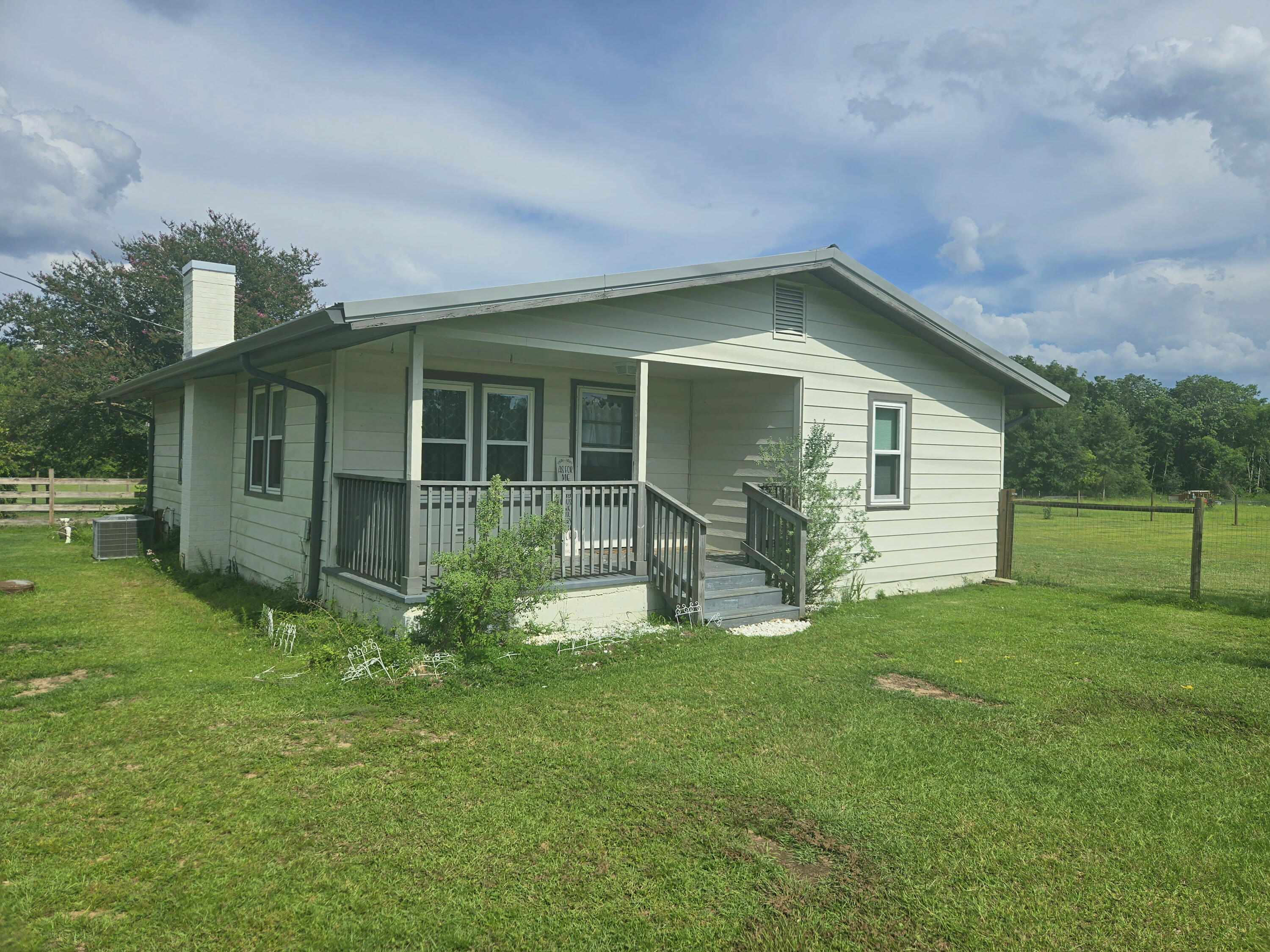 A beautifully reimagined farmhouse where timeless character meets true peace of mind. Thoughtfully updated throughout, this 3-bedroom charmer sits on a level 1.10-acre lot shaded by mature trees--with the big-ticket work already done. New electrical panels, HVAC and complete re-pipe (2020), water heater (2021), durable metal roof, stainless appliances (2020-2021) and a 2023 stove mean you can simply move in and enjoy. Inside, gorgeous wood-planked flooring brings a warmth and rustic character. A massive living room centers on a semi-built-in fireplace framed in classic board-and-batten, while the dining room is ready for holiday gatherings. Beyond the signature barn-style door, the kitchen shines with granite countertops, center island, generous storage, updated cabinetry, subway-tile backsplash and stainless appliances. Outside is where the magic unfolds: a covered back deck overlooks the manicured, park-like backyard, above-ground pool, chicken coop, play area and firepit ringed with built-in swings. A 50' x 42' pole barn with a 42' x 14' concrete area, plus a 24' x 16' storage building, provide exceptional space for tools, toys and equipment. Historic charm, modern comfort and room to breathe--this is more than a house; it's a lifestyle. Step inside and this beautifully reimagined farmhouse begins to reveal what makes it special. The warm, light-filled living spaces pair the character of a farm home with thoughtful modern updates designed for today's lifestyle. Gorgeous wood-planked flooring runs underfoot adding a rustic warmth throughout.

The massive living room is anchored by a semi-built-in fireplace framed in classic board-and-batten--the kind of inviting centerpiece you'll naturally gather around on cool evenings. The adjoining dining room offers plenty of space for holiday dinners, Sunday meals and easy entertaining.

Slide open the signature barn-style door and step into a kitchen that's as functional as it is beautiful. Rich granite countertops, a center island, generous storage, crisp updated cabinetry, classic subway-tile backsplash and gleaming stainless appliances create a space made for everything from quiet morning coffee to meals shared with family and friends.

The primary bedroom and two additional bedrooms provide restful retreats, while the updated bath brings a touch of everyday luxury with its tiled shower and new vanity.

One of the home's most delightful surprises is the bright, sun-drenched bonus room--a cheerful space that seems to invite you to stay awhile. Picture savoring your first cup of coffee as the day breaks, curling up with a good book on a lazy afternoon, or nurturing a collection of thriving houseplants in the natural light. Whether you envision a sunny home office, peaceful reading retreat, playroom or simply a quiet place to unwind, this inviting room adapts effortlessly to the way you live. A large walk-in laundry room adds everyday convenience.

But the true magic is outside.

Step onto the covered back deck and look across a manicured, park-like backyard shaded by mature trees and surrounded by room to breathe. Cool off in the above-ground pool on a summer afternoon. Gather fresh eggs from the chicken coop. Watch children make adventures of their own in the massive play area. Then, as evening settles in, gather around the firepit ringed with built-in swings beneath a starry sky.

With 1.10 level acres, there's space to roam, garden, play, entertain and simply enjoy being outside. And when it comes to storage and versatility, this property delivers in a big way. The impressive 50' x 42' pole barn includes a substantial 42' x 14' concrete area, offering tremendous possibilities for equipment, projects, hobbies, recreational toys and more. A separate 24' x 16' storage building provides even more room for the things that make country living easy.

Out front, the covered porch offers something increasingly rare: a place to simply slow down. Settle into a chair with a glass of sweet tea, listen to the quiet and watch the world go by.

And behind all that character is something equally important--peace of mind. Major improvements have already been completed, including new electrical panels, HVAC and a complete re-pipe in 2020, a 2021 water heater, durable metal roof, stainless appliances from 2020-2021 and a 2023 stove.

More than a house, this is a lifestyle--a place where historic farmhouse character, modern comfort and extraordinary outdoor living come together on more than an acre of your own. It's a home for morning coffee and summer swims, fresh eggs and garden rows, holiday dinners and evenings around the fire.

There's room here to gather, room to play, room to create and room to breathe.

Come see why this one doesn't just look like home--it feels like home.