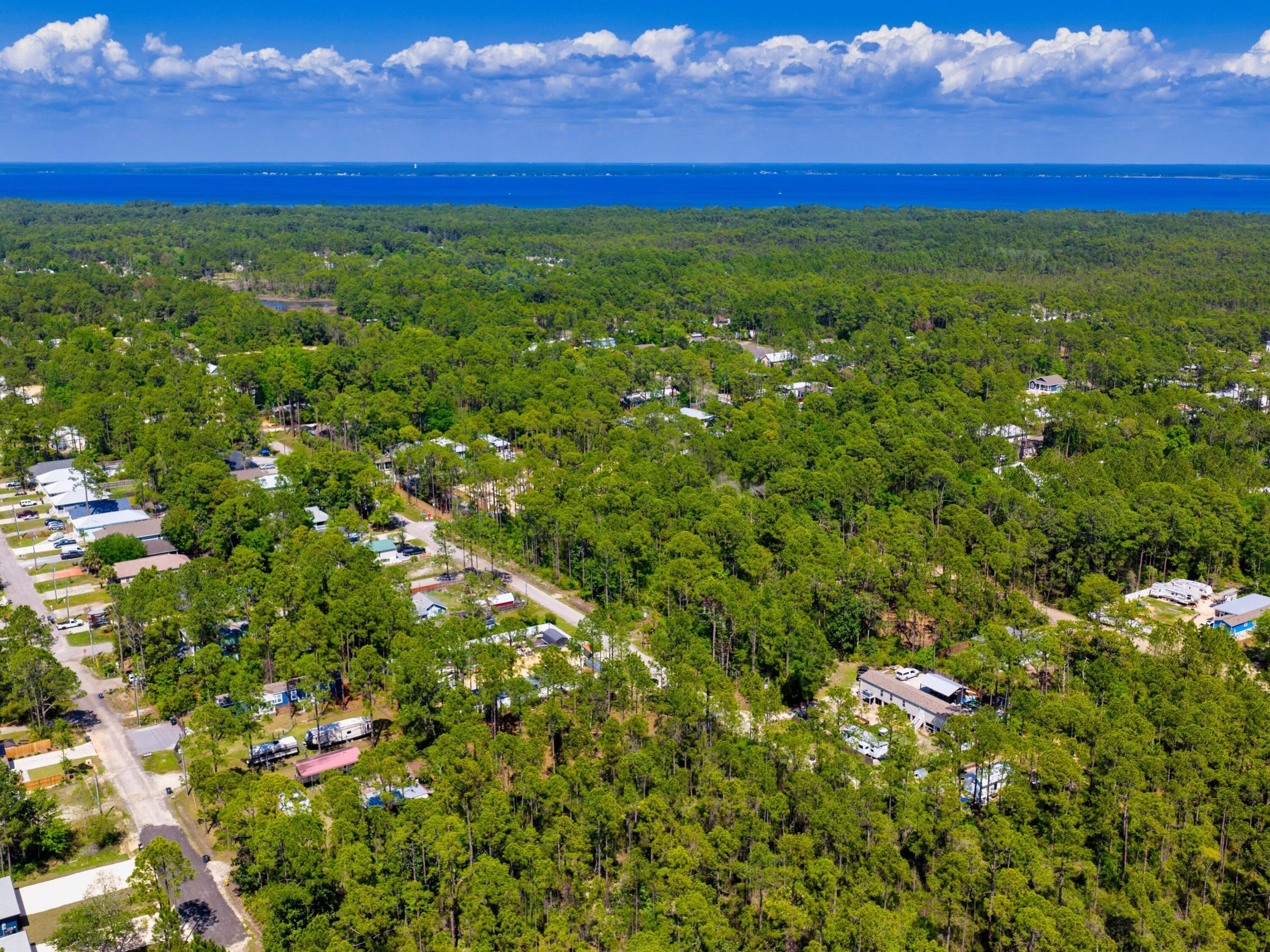 A spacious homesite with mature landscaping that would be ideal for a primary residence, vacation home, or an income-generating property. The property is not subject to homeowners association regulations and does not require a build-out period. It is conveniently located near the Cessna Landing boat launch and the restaurants, shops, and beaches of South Walton.