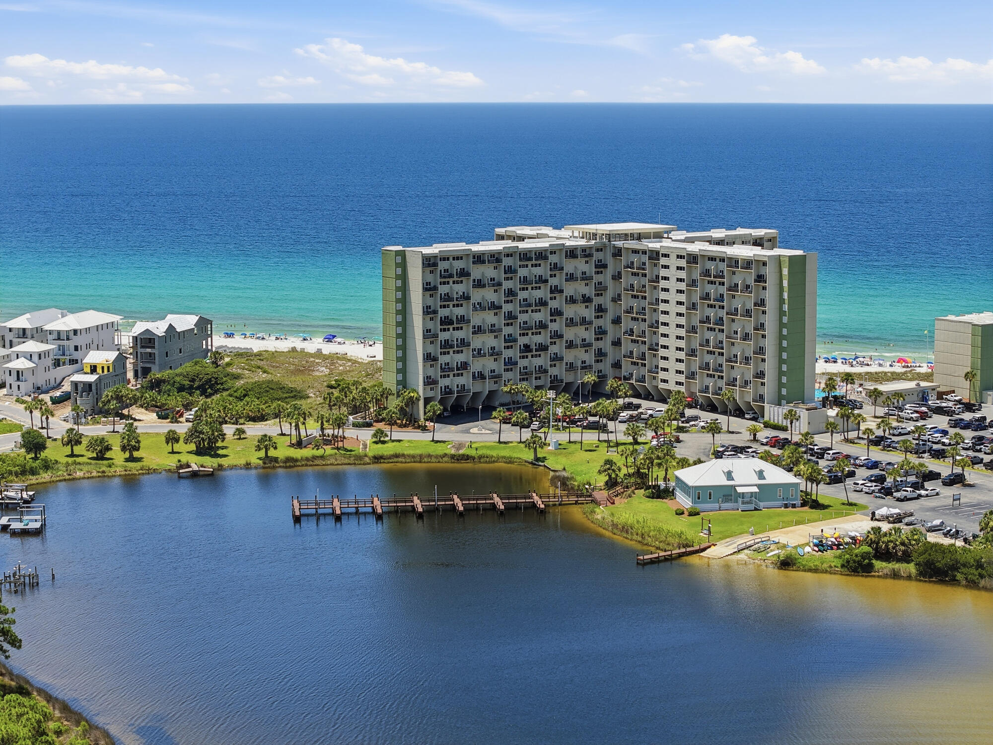 One of the few opportunities currently available at Pinnacle Port with an EXCEPTIONAL rental history, this beautifully maintained condo offers an impressive calendar of bookings (almost every day turn around!), outstanding 5-star guest reviews, and a loyal base of returning visitors year after year. Those are most valuable trades in vacation rental business that is already established for this property! Professionally staged(yes, owner paid for it!), fully furnished, and truly turnkey, it's ready to continue its success as a high-performing vacation rental or become your own private coastal retreat. Finally, a waterfront property where you don't have to choose between the Gulf and the lake. Here, you can enjoy breathtaking Gulf sunsets from your living room while overlooking the peaceful waters of Lake Powell from the dining area and primary suite - a combination so rare that it truly sets this condo apart. Inside, the thoughtfully updated interior features an open-concept kitchen with granite countertops, a breakfast bar, and spacious living areas designed for entertaining. Upstairs, the loft has been transformed into a private retreat with a custom stone and tile shower and a sliding barn door, creating a flexible space for owners and guests. Unit perfectly located in the center of the building at perfect height, and close to the elevator! Pinnacle Port is one of Panama City Beach's most unique waterfront communities, tucked behind the gates of Carillon Beach on 25 acres where the Gulf of America meets Lake Powell-Florida's largest coastal dune lake and one of the world's rare ecosystems where freshwater naturally connects with the Gulf. Spend your mornings watching dolphins offshore, your afternoons boating or fishing on the lake, and your evenings enjoying spectacular sunsets--all without leaving the community. Residents enjoy two pools, tennis and pickleball courts, a fitness center, sauna, private marina with boat slips and boat launch, fishing dock, and direct beach access. Bordering Camp Helen State Park, you'll also enjoy miles of preserved coastline, hiking trails, kayaking, wildlife, and one of the most peaceful stretches of beach along the Emerald Coast. Just minutes from the boutiques, restaurants, and entertainment of 30A, Rosemary Beach, Alys Beach, and Pier Park, Pinnacle Port feels like a secluded island retreat while remaining close to everything the Emerald Coast has to offer. An added bonus? Association dues include electricity for heating, cooling, and hot water, helping keep ownership costs more affordable.