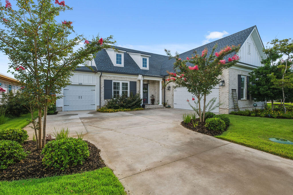 This home is all about how you want to live, not just where you sleep at night. It combines sophisticated interior design with luxurious, low maintenance outdoor living, all crafted by an award winning builder.
This gorgeous two story 2022 home in Deer Moss Creek is truly move in ready and designed for real life. Tucked on a quiet cul de sac, it offers three bedrooms plus a separate office, three and a half bathrooms, an open concept floor plan, and a three car garage that gives you space for cars, toys, and storage. From the moment you walk in, you feel a natural flow, from quiet mornings with coffee to evenings spent hosting all of your favorite people.
On the main level, the light filled living room flows into the dining area and stylish kitchen with a fabulous island, creating an easy gathering space for everyday living and entertaining. The dedicated office provides a private, quiet workspace away from the main living areas. The dining area features beautiful understated modern wallpaper that adds a touch of contemporary sophistication. 
The primary suite on the first floor feels like a boutique hotel retreat. A dramatic feature wall in the bedroom sets the tone for luxury and style, while the spa inspired bathroom and oversized walk in closet deliver comfort and functionality. Just off the living area, a covered back porch connects to an extended patio, creating a luxurious two level outdoor space.