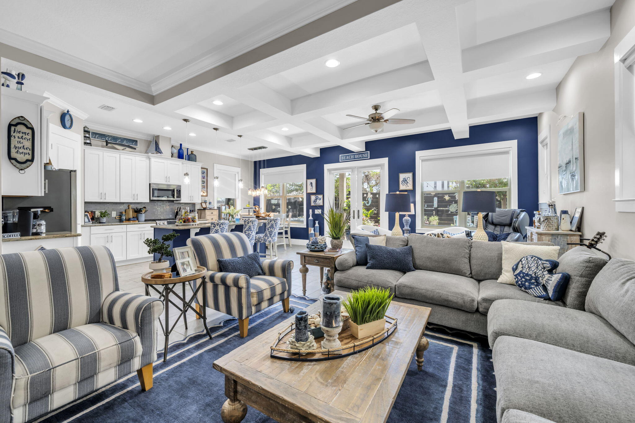 Welcome to this inviting coastal retreat with a private garden oasis! Designed for effortless days at the beach and relaxed evenings at home, this beautifully updated four-bedroom, three-and-a-half-bath residence offers a turnkey beach retreat just a short stroll from the white-sandy shoreline. Fully furnished with upscale designer décor, the home pairs polished interiors with a private backyard oasis, creating an inviting setting for a second home or vacation rental. Inside, 10-foot coffered and tray ceilings add architectural character while designer lighting, painted accent walls and thoughtfully selected furnishings bring a refined coastal aesthetic throughout. Wide-plank tile flooring extends across the main level with hardwood flooring upstairs and along the staircase. Two covered porches and a private balcony provide additional spaces to enjoy the coastal setting. The kitchen is appointed with quartz countertops, subway tile and Bosch stainless steel appliances, offering a clean, contemporary backdrop for entertaining. Quartz surfaces and subway tile continue into the baths while the spacious primary bath features a large walk-in shower with multiple shower heads. Outdoors, the private garden creates an unexpected retreat of its own. Updated landscaping surrounds a turf lawn with a putting green while a hot tub and comfortable lounge area offer plenty of room to unwind after a day at the beach. Private beach access puts the Emerald Coast shoreline within easy walking distance, while community amenities include a swimming pool, tennis courts, and the popular Sandos Beachside Cafe & Bar for coffee and cocktails! With designer furnishings, inviting indoor and outdoor spaces, and beach access close at hand, this thoughtfully appointed home is ready to enjoy as a coastal getaway, second residence, or vacation rental.