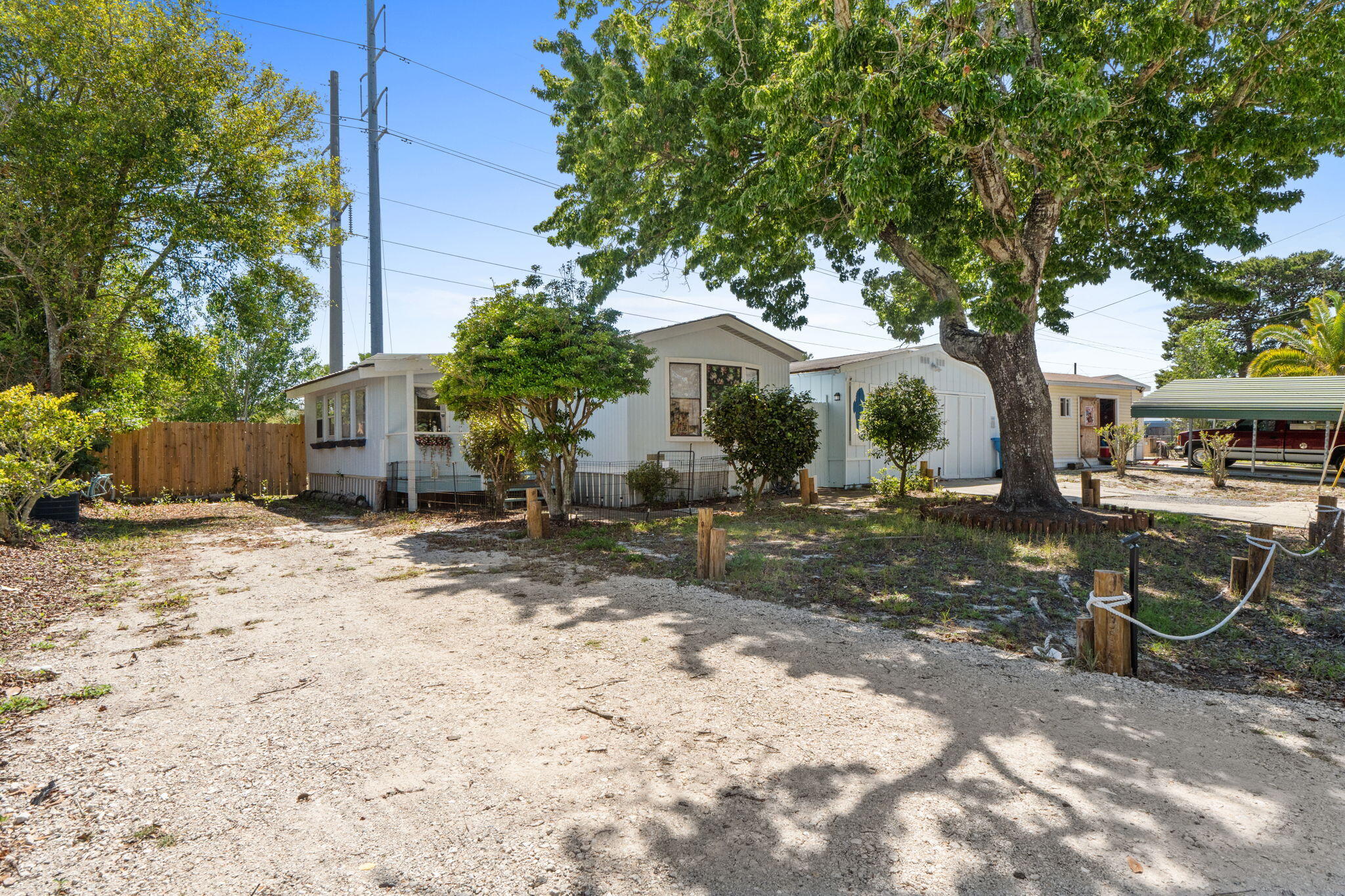 Welcome home! This home offers comfort and great outdoor living all less than 10 minutes from Pier Park and the beach! Whether you're looking for a primary residence, beach getaway, or investment opportunity, this property checks all the boxes! The home is already registered as real property, and includes every single thing you see - vacation rental ready! Roof and water heater replaced in 2022 and inside, you'll find stainless steel appliances and LVP flooring. Step out back and the property really shines! Enjoy a fully fenced yard, a spacious back deck, and an above-ground saltwater pool - perfect for relaxing or entertaining. The outdoor shower and bar area make it easy to rinse off and unwind. A detached garage and storage shed provide plenty of room for tools, toys, or hobby space