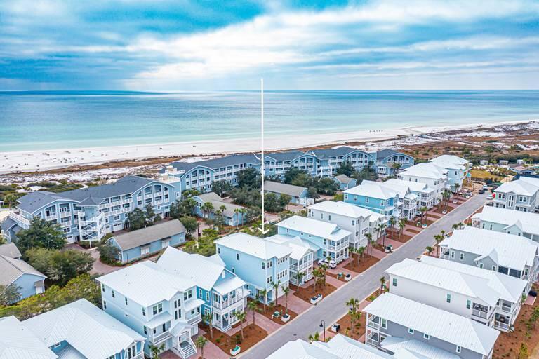 Just Listed- fully furnished, and complete with a golf cart, this coveted ''Bora Bora'' floor plan is completely turnkey and includes a private elevator providing effortless access to all three levels. Perfectly positioned on the quiet south side of Prominence, this exceptional coastal retreat enjoys Gulf views and is just a short stroll to the exclusive members-only WaterSound Beach Club and the private WaterSound Beach access gate. Offering four bedrooms and 3.5 baths, including two spacious primary suites--one on the main living level and another on the third floor--this thoughtfully designed home provides the ideal layout for both everyday living and vacation getaways. The first floor features custom-built bunk beds, a spacious secondary living area, a full bath, a walk-in closet, large owners closet, and direct access to the private backyard, creating the perfect retreat for guests or additional entertaining space. Light-filled coastal interiors showcase rich hardwood floors, 10-foot ceilings, crown molding, shiplap accents, and walls of windows that bathe the home in natural light. The chef's kitchen is beautifully appointed with a natural gas cooktop, premium stainless steel appliances, abundant cabinetry, a walk-in pantry, and an oversized island designed for gathering family and friends. The open-concept floor plan flows seamlessly into the expansive living and dining areas, creating an inviting space for entertaining.
Three covered porches capture beautiful Gulf views and provide the perfect setting for morning coffee, afternoon breezes, or spectacular sunset evenings. Located just moments from The Big Chill, residents enjoy easy access to popular dining, shopping, entertainment, and community events, while Prominence offers two resort-style pools, a fitness center, expansive green spaces, and convenient access to Deer Lake State Park. 
Spanning 3,462 square feet, this home has been thoughtfully curated with every detail for effortless coastal living. Whether you're seeking a luxury vacation retreat, an investment property, or an exceptional full-time residence, this beautifully appointed home offers the perfect blend of luxury, location, and lifestyle.