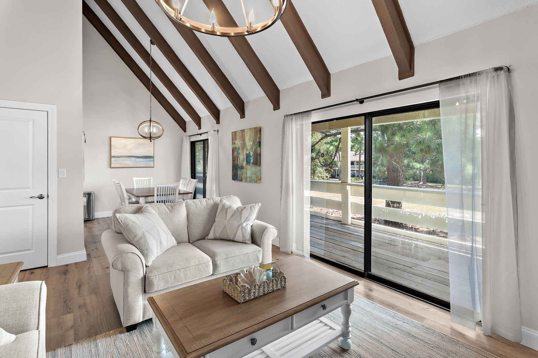 Tucked into one of the most private settings at Seascape Resort, this second-floor end unit offers a rare combination of seclusion and views. From the balcony, take in the golf course between the 5th and 8th holes, with no neighbors crowding the outlook. This is one of the quieter corners of the resort, a short walk from everything but removed from the traffic.
The 2-bedroom, 2-bath villa spans approximately 1,110 square feet and has never been rented, kept in excellent, like-new condition throughout. It's offered fully furnished and turnkey, with rental income potential exceeding $50,000 per year for the investment-minded buyer. The interior has been thoughtfully renovated with an eye for durability and design. Luxury vinyl flooring with soundproofing and waterproofing runs throughout, paired with white cabinetry, updated hardware, granite countertops, and stainless Whirlpool appliances in the kitchen. A Culligan water filtration system is already in place. The living area rises to soaring vaulted ceilings with exposed wood beams, anchored by a statement chandelier that adds warmth.
The primary bath is a standout: a dual rainhead shower system set against wood-look tile, finished with a pebble stone floor for a spa-like feel that's hard to find in a villa this size.
Seascape Resort itself spans more than 300 acres along the Gulf, with deeded beach access, a championship golf course, tennis and pickleball courts, and multiple pools throughout the property. Just steps from the beach, the Whale's Tail Beach Bar & Grill has been a Destin landmark for decades, known for its Gulf-front deck and standout sunset views. The resort's Town Centre adds an easy layer of everyday convenience, with a mix of dining, a wine and spirits shop, and family entertainment like laser tag and an arcade, all just a short distance from the villa.
Whether as a full-time residence, second home, or turnkey rental, this is a well-maintained, move-in ready opportunity in a quiet, private pocket of one of 30A's most established resort communities.