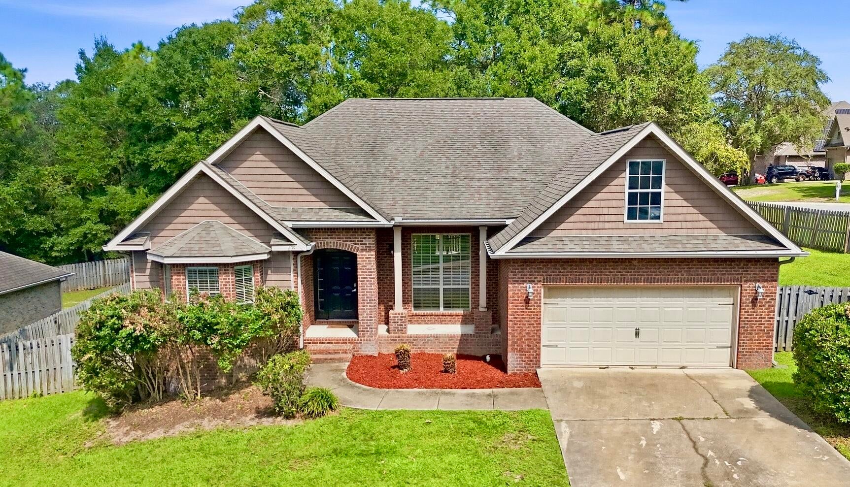 Welcome to 639 Red Fern Rd! This brick home sits in Crestview's well established Fox Valley neighborhood, with thoughtful updates throughout and the kind of curb appeal that makes you want to pull into the driveway. It's conveniently located near Eglin AFB, Duke Field and 7th SFG. The first thing you'll love is the stylish entryway, a built in drop zone that shows home the minute you walk in. The newly updated kitchen is the heart of the home. Sage green cabinets, granite counters and warm wood shelving give it a farmhouse inspired feel that's calm, welcoming and full of natural charm. The kitchen flows right into the vaulted, spacious living room. Just off the kitchen, the breakfast nook has a charming built in beverage station, a butcher block counter and beverage fridge. Picture your morning coffee bar here or a spot to set out drinks when friends come over. A formal dining room is ready for holidays and bigger dinners. The updated master with new flooring and modernized spa-style bath is a true retreat with direct access to the covered porch set up for gardening. The revised office has new flooring, a whole wall of built in desks, lights and cabinets so there's room for everything. The workbench in the garage is for all the weekend and DIY projects. An upstairs bonus room gives you even more space for a playroom, gym or guest area. Schedule your showing today, your future home on Red Fern is waiting! Offering $5000 credit to buyer w/ acceptable offer