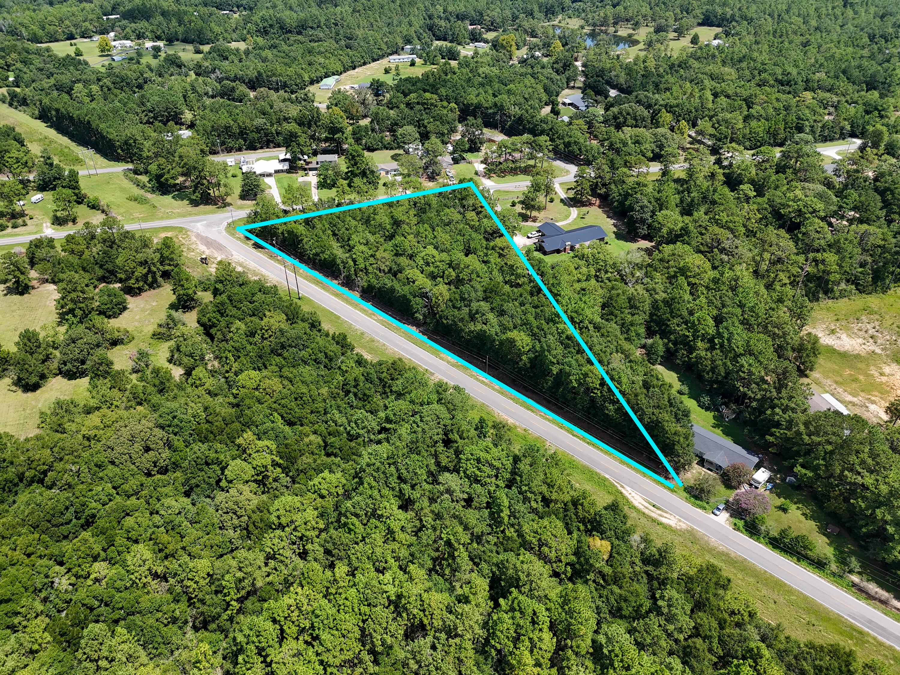 This wooded high and dry 2.5 acre homesite is ideally located south of I-10, a mere 30 minutes or less drive to the beaches, on the corner of Coy Burgess Rd. and John White Rd. Lot is level, will require well and septic, with electricity easily available. Plenty of room for a home, outdoor amenities like barn/shop, or pool; and because it's located within the county with NO HOA, there aren't restrictions for manufactured homes, etc. Zoning and FLU is Estate Residential. Just a 5 minute drive to downtown DeFuniak Springs and less than that to hop on I-10. Survey in hand, ready for a quick closing.