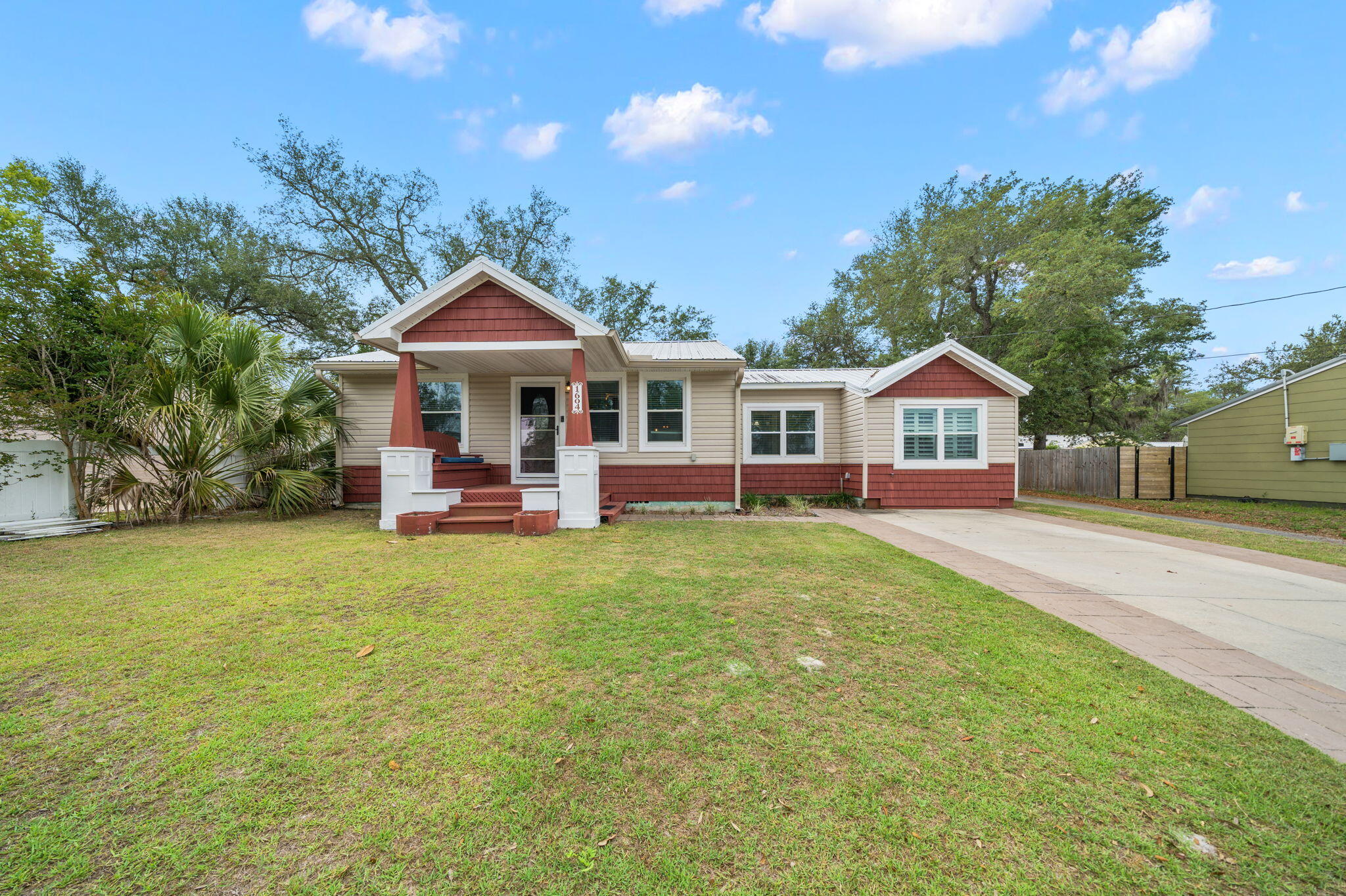 Across from the Bay in the historic Cove neighborhood sits a home exuding charm and character offering 3 bedrooms, 2.5 baths, a detached home office with an adorable front porch! 

This Cove cottage features almost 1800 square feet of living space with a large open deck on the back, overlooking the shaded back yard, perfect for entertaining. You're greeted with a cozy, covered front porch and enter into a stunning great room with custom millwork throughout including a stunning coffered ceiling flowing throughout the living room, kitchen and dining area. The living room is flooded with natural light, spacious and includes a separate area great for kids to play or would function as a great conversation area. The kitchen is outfitted with beautiful granite countertops, stainless steel appliances and a gas cooktop with accent lighting above the cabinetry. The dining room overlooks the backyard with lush oak trees. 

Just off the kitchen is a guest bedroom with en suite bath complete with a tub/shower combo. An additional guest bedroom is found toward the back of the home off the dining room. A great feature of this home that is rare in Cove homes is a half bath which is in an excellent location for guests - just off the living room area. The hallway with the powder room leads to the primary suite which is a true retreat! The primary suite includes double closets, vaulted ceilings, natural light and a en suite bath to include a dual shower head, oversized tiled shower, double vanities and water closet. This home is a true split floor plan! 

One of the best features of this home is the building in the backyard. This 2023-built permitted outbuilding has a home office complete with plumbing and electrical and a half bath. This is an incredibly desirable feature for those who wish to work at home but be separated from the home for work. The outbuilding also has a work shop area great for hobbies and outdoor work. This building is also insulated for temperature control and encapsulated to keep it free from pests. The right side of the home also gives access to a city-maintained alley that runs along the back yard fence and gives easy access for trailers, boats, etc. 

1604 Tyndall Drive offers a 2020 roof, 2019 windows, 2020 HVAC, tankless water heater, whole house surge protector, Aquasauna water filtration system (complete with 6 months of filters!) and 2017 Maytag appliances. The Cove is a charming golf cart-friendly community with NO HOA and highly sought after for it's water views as well as its city-maintained playgrounds and parks. Just 2 homes down from this home you'll also enjoy a baseball field and new playground area for kids and families. Enjoy events in the community throughout the year! This neighborhood is adjacent to the fast-growing downtown Panama City area which features restaurants, a marina, shopping, breweries, farmers markets and events year-round. The St. Andrews Bay Yacht Club is an incredible offering as an addition amenity in the neighborhood and just a few minutes away. Ideal for boaters, fisherman and those who love to enjoy events, as a member, you will enjoy access to a private boat launch, dining waterfront and activities weekly. 1604 Tyndall Drive in the heart of the Cove is waiting for you!