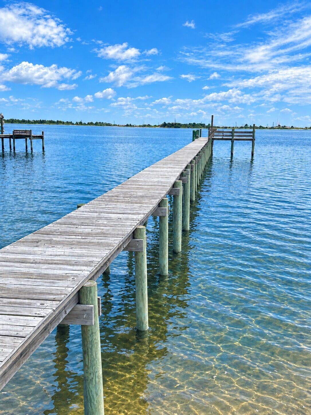 BUILD YOUR WATERFRONT DREAM HOME ON SANTA ROSA SOUND! This cleared, approximately 0.58-acre (25,000+ SF) vacant lot in the Sparkling Waters community offers approximately 103 feet of white-sand waterfront with unobstructed views across Santa Rosa Sound toward Santa Rosa Island. A private dock extends approximately 200 feet over the Sound, providing direct water access for boating, kayaking, paddleboarding, fishing and other water activities. Imagine designing your custom home to take advantage of the waterfront setting and expansive views. Conveniently located between the Destin and Pensacola areas by road, with boating access toward Crab Island and the Gulf of Mexico. Underground utilities are reported available to the lot, and water tap fees are reported paid. Bring your building plans and create your waterfront retreat on Santa Rosa Sound.