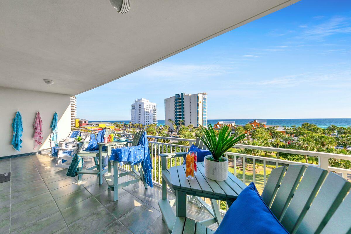 Completely reimagined with sophisticated coastal style and exceptional attention to detail, this beautifully remodeled residence offers an elevated beachside lifestyle within one of Destin's premier resort communities. Showcasing sweeping gulf views, an extraordinary oversized balcony and an enviable location overlooking the resort's spectacular pools, this turnkey condominium is equally suited as a luxurious personal retreat or a high-performing vacation rental. Designed for effortless living and entertaining, the open-concept floor plan encompasses two bedrooms, two bathrooms and inviting living spaces filled with natural light. The spacious living room opens directly onto the expansive balcony, allowing the gulf views and coastal breezes to become part of everyday life. Elegant finishes, updated flooring and refined coastal interiors create a timeless atmosphere throughout. The beautifully renovated kitchen combines style and function with stone countertops, stainless steel appliances, exquisite new cabinetry, generous preparation space and a breakfast bar ideal for casual meals or entertaining. The adjacent dining area provides ample room for gathering after a day at the beach. Privately positioned, the primary suite offers direct balcony access, breathtaking gulf views, a spacious walk-in closet and a beautifully updated ensuite featuring double vanities, stone countertops and a large walk-in shower. The guest bedroom is equally inviting, while a sleeper sofa in the living area allows the residence to comfortably accommodate up to six guests. A full-sized washer and dryer provide additional convenience for owners and visitors alike. One of the home's most remarkable features is the oversized balcony. Furnished with bar-height Polywood seating and Adirondack rockers, it offers an exceptional outdoor living space for morning coffee, dolphin watching, afternoon relaxation or unforgettable sunset evenings overlooking the gulf, lagoon pool and tropical grounds. Residents and guests enjoy an impressive collection of resort amenities including a spectacular 4,300-sq.-ft. lagoon-style pool surrounded by lush tropical landscaping, a private gulf-front beach club with a seasonally heated pool, seasonal food and beverage service, private beach access, a 24-hour fitness center, BBQ grilling areas and beautifully maintained gated grounds. Seasonal beach service is available and includes two chairs and an umbrella, further enhancing the coastal experience. As a bonus, this incredible property includes a secured, climate-controlled 46" x 70" ground-floor storage space. Ideally located in the heart of Destin, Sterling Shores places owners just a short walk from The Back Porch and only minutes from Destin Commons, the Harbor Boardwalk, Big Kahuna's Water & Adventure Park, The Track and an outstanding collection of shopping, dining and entertainment. World-famous white sand beaches, championship golf, boating, fishing charters and endless opportunities for waterfront recreation make this one of the Emerald Coast's most desirable destinations for both homeowners and vacationers alike.