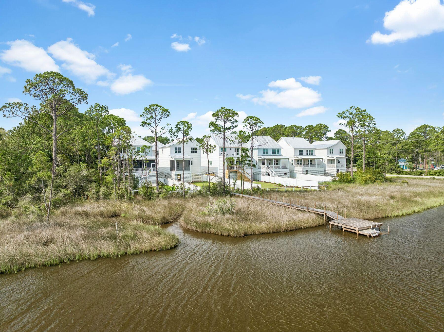 Beautiful waterfront home on Hogtown Bayou offering breathtaking bay views and the perfect blend of coastal charm and modern convenience. Built in 2023 and impeccably maintained, this 3-bedroom, 2.5-bath Florida cottage feels like new.

The open-concept floor plan features beautiful flooring, crown molding, and a bright, inviting kitchen with a center island designed for effortless entertaining. Upstairs, you'll find all three bedrooms along with a conveniently located laundry area.

Step outside to the spacious covered back deck and unwind while taking in spectacular sunset views over the bay, or enjoy fishing, kayaking, and paddleboarding from your private dock. Enjoy your fenced in backyard with enough space to add a private pool! 

Located directly across from Cessna Landing County Park, you'll have immediate access to a public boat launch, making it easy to explore Choctawhatchee Bay and the surrounding waterways by boat. When it's time for the beach, Ed Walline Regional Beach Access on 30A is approximately 3.6 miles away--just one left turn down County Highway 393 to the sugar-white sand and emerald Gulf waters. Supplemental boat storage available nearby.

Additional features include a covered carport, natural gas, a tankless water heater, and an unbeatable location. Whether you're searching for a primary residence, second home, or investment property, this exceptional waterfront retreat offers the very best of the Florida lifestyle.  
 All square footage and room dimensions are approximate and should be verified by the buyer