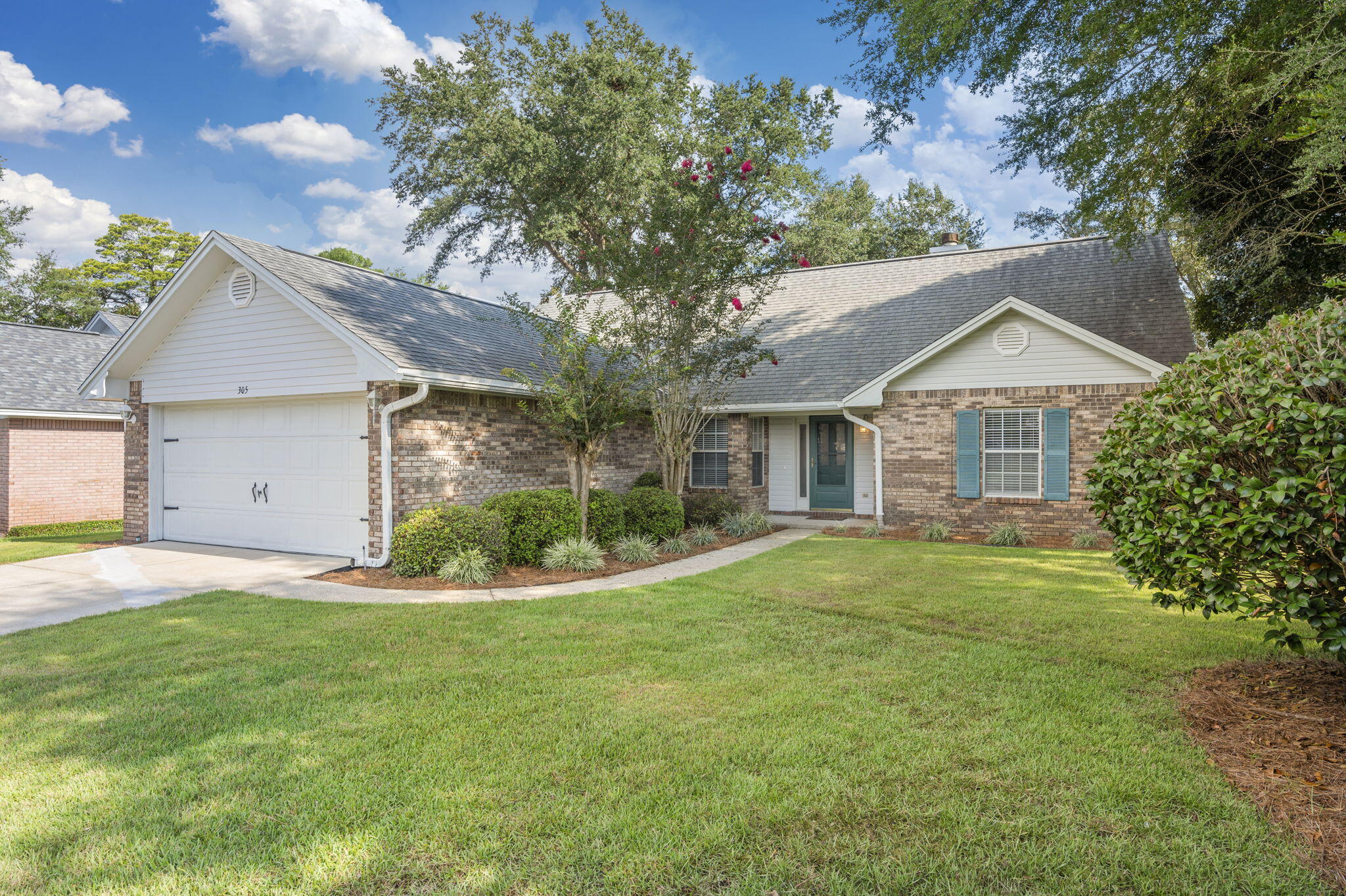 Welcome to this beautiful brick home located in the desirable Bluewater Bay community. This 3-bedroom, 2-bath residence offers a thoughtfully designed layout with both style and comfort in mind. Step into an inviting entryway with recessed lighting and luxury vinyl plank flooring, leading to a cozy carpeted living room featuring a stunning fireplace and mantel. The dedicated dining room boasts two windows overlooking the front yard, perfect for enjoying natural light during meals.

The fully appointed kitchen includes stainless steel appliances, a gas range, custom island, stone countertops, and a window above the sink--ideal for both everyday living and entertaining. The spacious primary suite is conveniently located on the first floor and includes a dual vanity bathroom with a custom tiled walk-in shower and glass enclosure. The two additional bedrooms are carpeted with ceiling fans and share a guest bath with a tiled shower/tub combo and stone countertop vanity. Upstairs, a bonus room offers flexibility for a home office, playroom, or guest space.

Enjoy year-round relaxation in the large screened-in Florida room, which opens to a beautifully landscaped backyard with mature trees, a privacy fence, and a wood deck--perfect for outdoor entertaining. Contact us today for a showing!!!