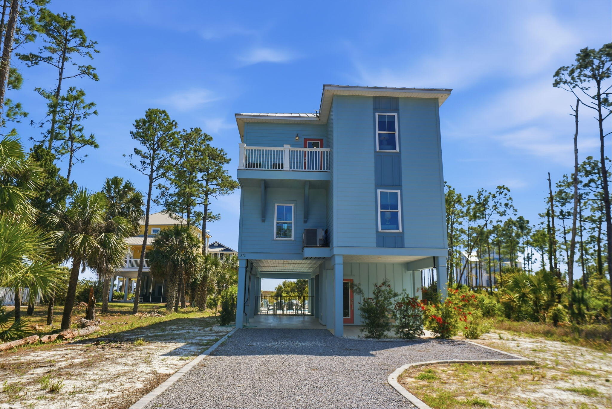 Welcome to a recently constructed coastal retreat where sweeping Gulf views greet you from both the first- and second-floor balconies, setting the tone for a true beachside escape just a short walk to the beach. Nestled in the laid-back, golf cart- and pet-friendly community of Indian Pass, this beautifully designed 4-bedroom, 4-bath home features two spacious primary King suites, each with its own Gulf-facing deck and en-suite bathroom complete with tiled showers and double vanities, creating a serene space. The property also has a 5' private deeded access to the gulf and a lagoon parcel across the street for added water access. Large bunk suite with two twin-over-twin bunks provides a fun and functional space, while a fourth bedroom with two full beds is conveniently located near a shared bath. The top floor serves as the heart of the home, where an open-concept great room showcases expansive Gulf views, a comfortable living area, and a well-appointed kitchen with stainless steel appliances, a wet bar, and ample dining space for everyone to gather. Designed with both relaxation and recreation in mind, the property offers a private pool with optional heating, a large deck overlooking the Gulf, and outdoor amenities that enhance the coastal lifestyle, including a gas grill, outdoor shower, and fish cleaning station. The ground level also features a commercial-grade ice maker, an additional refrigerator, and parking for multiple vehicles. An elevator provides convenient access to all floors. Located in the peaceful and scenic Indian Pass area, this home places you just moments from uncrowded beaches, the historic Indian Pass Raw Bar, and the charming coastal communities of Port St. Joe and Apalachicola, where you'll find local dining, shopping, and Old Florida charm. This property offers the ideal blend of comfort, space, and location for an amazing Gulf Coast getaway. Some dimensions taken from the Gulf County Property Appraiser's website, verify if important.