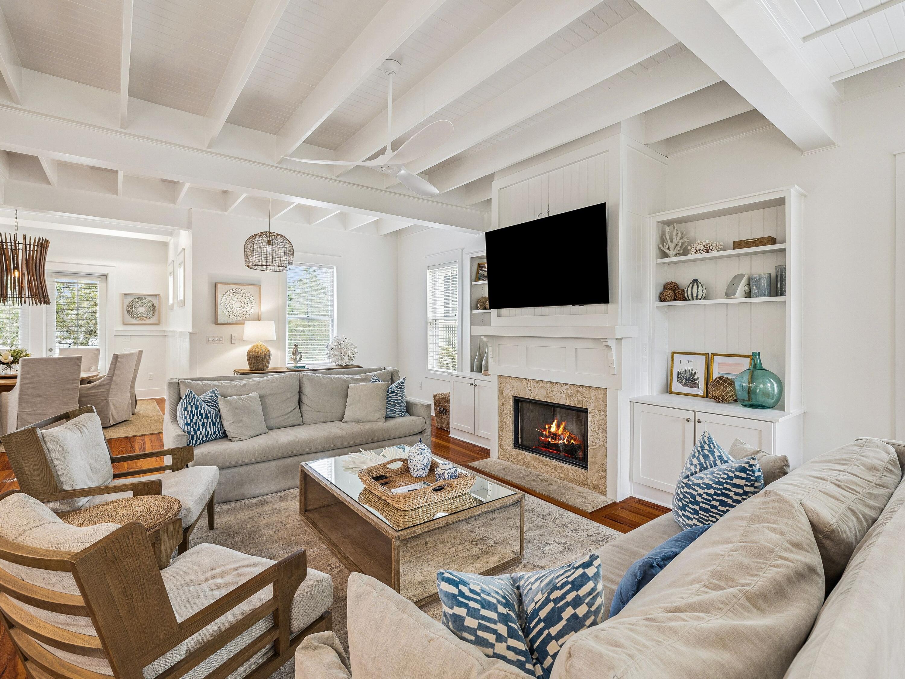 Buffered by mature greenery on a private corner lot in WaterColor Phase I, 90 Silver Laurel Way captures the essence of classic Florida cottage architecture paired with the comfort and refinement of a thoughtfully updated coastal retreat. Just two blocks from the sugar-white sand and a short walk or golf cart ride to the WaterColor Beach Club, Boathouse, and scenic trails, the location places the very best of the community within easy reach. Designed for effortless indoor-outdoor living, the residence features four spacious porches, including screened and open-air spaces ideal for relaxing or entertaining. A paved backyard terrace offers additional gathering space with room for a future pool pending approval, all framed by a lush, private setting.
Spanning approximately 3,316 square feet across three levels, the home offers five bedrooms and five bathrooms, including two primary suites--one on the main level and another on the third floor with Gulf views. Rich hardwood flooring, vaulted ceilings with exposed beams, recessed lighting, and a soft coastal palette define the interiors.

The open-concept living area flows seamlessly into the dining space and kitchen, appointed with quartz countertops, premium stainless steel appliances, and a Sub-Zero refrigerator. A gas fireplace with custom built-ins anchors the living room, while an adjoining bar area and breakfast nook enhance the home's inviting atmosphere.

Additional highlights include updated bathrooms, surround sound, multiple owner storage closets, covered parking, and an extended paved driveway. Residents of WaterColor enjoy access to resort-style pools, tennis courts, fitness amenities, Camp WaterColor, dining venues, and scenic walking trails, with Seaside just moments away.

Offering privacy, thoughtful design, and a prime location near the Gulf, 90 Silver Laurel Way presents a timeless coastal retreat within one of 30A's most sought-after communities.