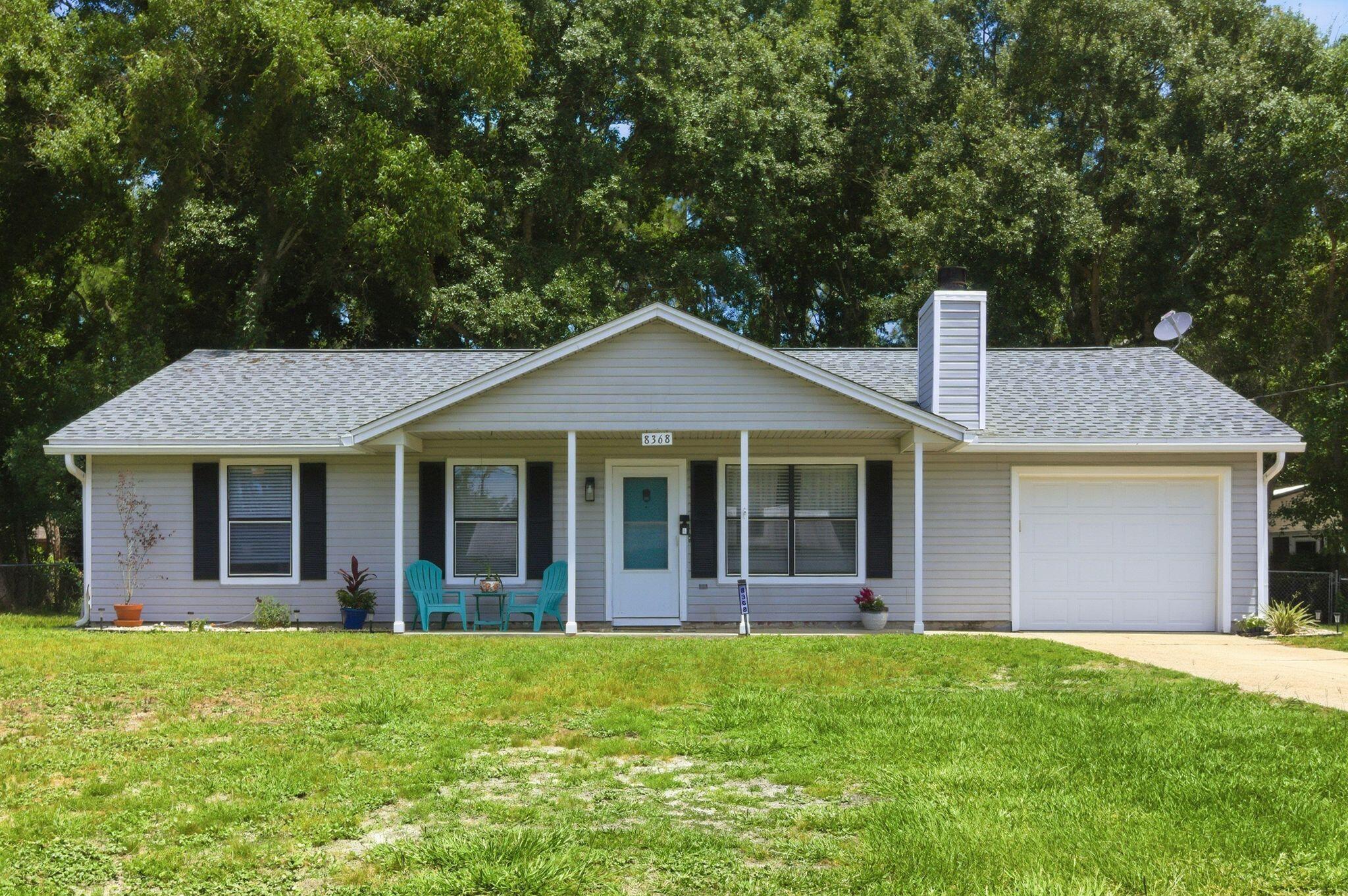 Welcome to the hidden gem you've been searching for! Situated on nearly half an acre in the heart of Navarre, this surprisingly spacious 5-bedroom, 2-bath home offers room to spread out, grow, and enjoy the Florida lifestyle without the restrictions of an HOA.

Don't let the front view fool you--this home is much larger than it appears. Inside, you'll find luxury vinyl plank flooring throughout, fresh interior paint, updated 2' faux wood blinds, stainless steel appliances, and beautifully remodeled bathrooms. The cozy living room features a wood-burning fireplace, creating the perfect gathering space for family and friends.

One of the home's standout features is the expansive rear addition, offering a large secondary living area that can easily serve as a family room, game room, home office, fitness space, homeschool area, or media room. Two additional bedrooms are located in this wing of the home and can be separated from the main living area by charming double barn doors--ideal for multi-generational living, teenagers, guests, or anyone needing extra privacy and flexibility.

Outside, you'll fall in love with the enormous chain-link fenced backyard. Towering mature shade trees create a peaceful park-like setting, while the flagstone patio and firepit provide the perfect backdrop for cookouts, s'mores, backyard football games, or relaxing evenings under the stars.

Major updates include a 2020 roof, 2017 HVAC system, 2017 water heater, 2023 dishwasher and microwave, and a  2024 range. A transferable termite bond with Arrow Exterminators offers additional peace of mind.

Location is everything, and this property delivers. Enjoy close proximity to Navarre Beach, convenient access to Publix, Starbucks, restaurants, and shopping via the back roads, allowing you to avoid much of the Highway 98 traffic. Pensacola is an easy commute, and two nearby airports make travel a breeze. As an added bonus, the world-famous Blue Angels occasionally fly overhead, providing an unforgettable show right from your own backyard.

If you've been looking for space, flexibility, a large lot, and a convenient Navarre location, this is a home you won't want to miss. Call your favorite agent TODAY!
