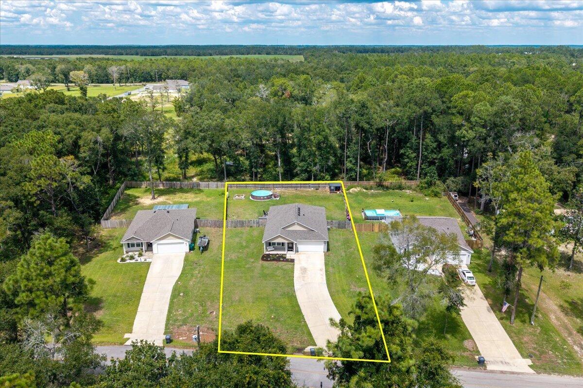 Why start from scratch when so many of the extras are already done? Built in 2024, this 4-bedroom, 2-bath home has already been improved with a privacy-fenced backyard, screened porch, irrigation system, extended paver patio, fire-pit area, above-ground pool, custom-tiled walk-in shower, and an impressive built-in closet system in the primary suite. Inside, the open living, dining and kitchen areas create a bright, comfortable space for everyday living and entertaining. The kitchen features granite countertops, stainless appliances, plenty of cabinetry and a walk-in pantry. LVP flooring flows through the main living areas, with carpet in the bedrooms. The primary suite is a standout, featuring a spacious walk-in closet with extensive built-in organization and a custom-tiled shower with bench, dual niches and upgraded fixtures. Out back, the .39-acre lot gives you room to enjoy Florida living--relax on the screened porch, gather around the fire pit, cool off in the pool or simply enjoy the fenced backyard. And when you're ready to get out on the water, Juniper Lake and nearby Cat Island Park offer opportunities for fishing, kayaking and enjoying the outdoors. Nearly new, already upgraded and ready to enjoy--148 Squirrel Road offers much more than the basics without waiting for a new build.