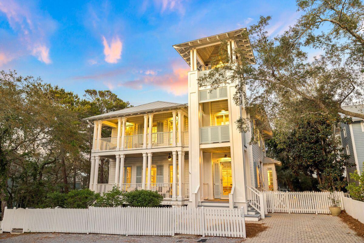 Nestled in the heart of Seaside, this beach home was built to encompass the refined style of one of 30A's original beachside communities.
Upon arriving at ''Taste and Sea'' you are welcomed by three stories of outdoor entertaining spaces, along with patios and decking to connect the main house to the fully serviced guest house. Through the generous front foyer, walk into the inviting living and dining room, dressed in a combination of modern and antique furnishings. Doric columns define each of the main areas on the first floor, but offer visibility from every room into the next. The Kitchen is equipped with everything a cook might need and is tucked away with pocket doors to allow entertainment to remain in the large indoor / outdoor living and dining spaces. The "Sugar Shack" guest house includes a full kitchen, laundry, and flexible living space. A first-floor day room can function as a bedroom, while the second-floor primary suite features a half bath and Juliet balcony overlooking the garden. Set on a larger, private lot backing up to Old Seagrove, the property offers strong outdoor living space in a central Seaside location.