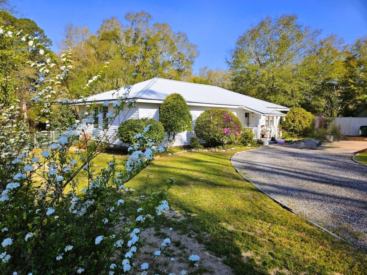 Rare opportunity in the historic district of DeFuniak Springs! Situated on an exceptional 1.42-acre parcel near the iconic Lake DeFuniak area, this charming 1945 home offers a unique blend of historic character, privacy, and space seldom found within downtown residential settings. Surrounded by mature trees and historic homes, the property provides endless possibilities for gardens, outdoor living, workshop space, guest quarters, or future expansion. Enjoy the charm of tree-lined streets, walkability to downtown amenities, and the rarity of owning one of the largest residential parcels in the area, with occasional deer visits . A truly unique historic district property with tremendous upside and long-term appeal. 

All information is believed to be accurate but is not guaranteed. Prospective buyers are responsible for independently verifying all information and determining the property's suitability for their intended use. All final terms are subject to negotiation and shall be set forth in a fully executed sales agreement between the parties. Enjoy a walkable lifestyle to downtown DeFuniak Springs, with its local shops, dining, and community events centered around the lake. Additionally, this location offers convenient access to the white sand beaches and world-class amenities of South Walton and Scenic Highway 30A, making it an ideal balance between small-town charm and coastal living.

This is a rare chance to secure a large homesite in a highly desirable historic setting--perfect for homeowners, investors, or those seeking a long-term land play in a growing market.