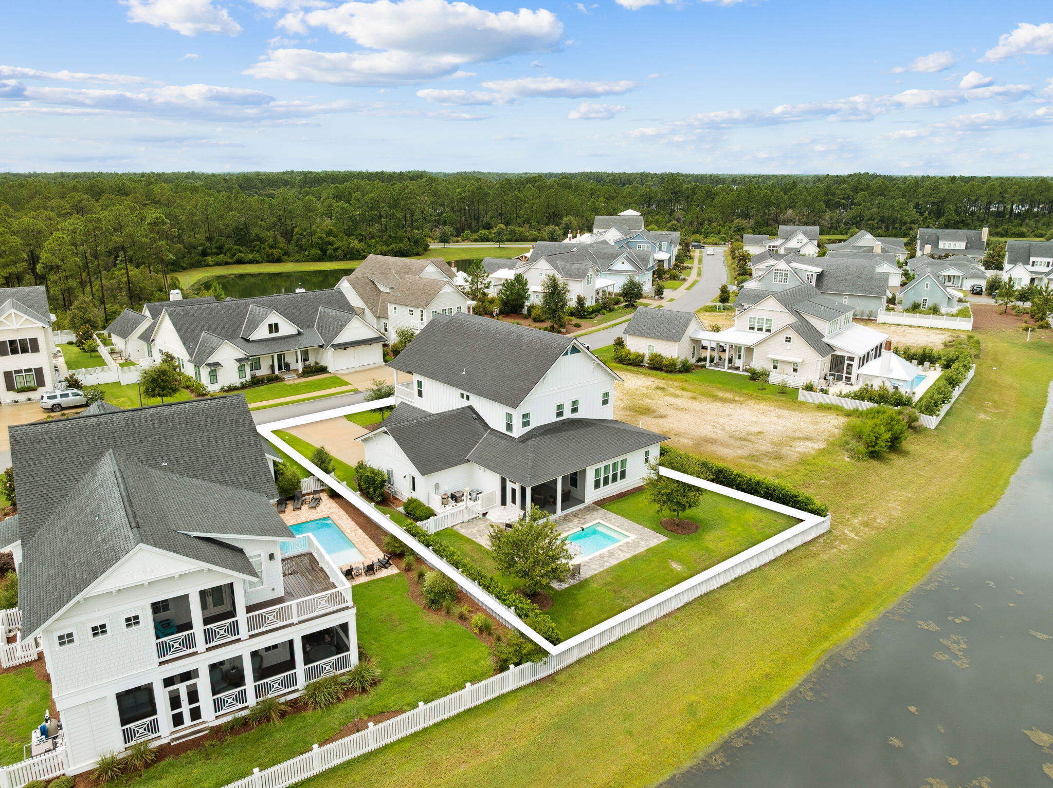 Located on one of the most sought-after streets in Watersound Origins, where most homes are custom-built, 121 Needle Cast Lane is a stunning Cogent-built custom home overlooking a tranquil pond. This beautifully designed 5-bedroom, 4.5-bathroom residence blends timeless architectural character with modern luxury, all within a relaxed, resort-style setting.
Boasting 10' ceilings and tongue & groove walls, the open-concept floor plan features an inviting front porch, spacious living and dining rooms, and a chef's dream kitchen. The U-shaped kitchen includes a 48'' Signature Kitchen Suite range with griddle, Viking dishwasher, Sharp microwave drawer, quartz countertops, abundant cabinetry, and a custom walk-in pantry with wood wine rack