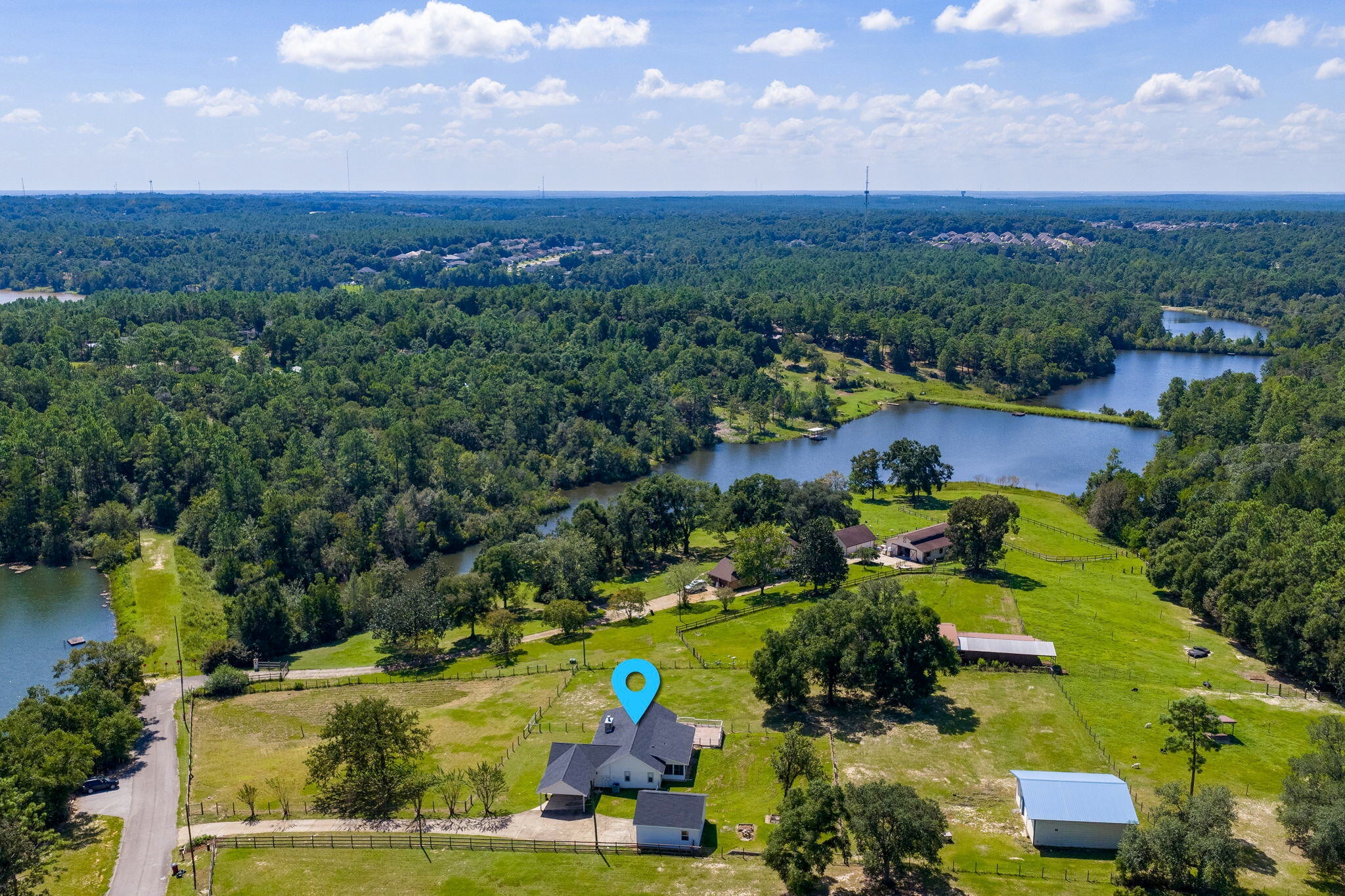 Have you ever dreamed of having your own horse ranch less than an hour from the beaches of Destin? Well, your dreams are about to come true with this beautiful estate on over 2 acres in the Kennedy Lakes area of Crestview! This unique property features 2.2 acres of fenced pasture with a 36'x36' barn/workshop and a large 24'x24' detached garage as well as a convenient carport.  The multi-purpose barn/workshop with both front and read doors recently stabled several horses and offers a 10x20 tack room, storage space, electricity and water. The charming home on the property has been completely renovated from top to bottom the past few years and it is the definition of MOVE IN READY! The wrap around porch with a delightful swing is the perfect place to unwind while gazing over the front pasture and out to Kennedy Lake. Coming through the front door, you will be in a hallway that leads to the living room and dining room that are open to the kitchen and breakfast bar. Or you can enter the home from the carport door that leads you to a large den with picture windows overlooking the pasture. This is a split floorplan with the master suite on one side of the home and two additional bedrooms on the other.  Along the back of the house is a screened porch and large sun deck overlooking the rear pasture area and barn. You really have to see this property and once you do, you will fall in love!!