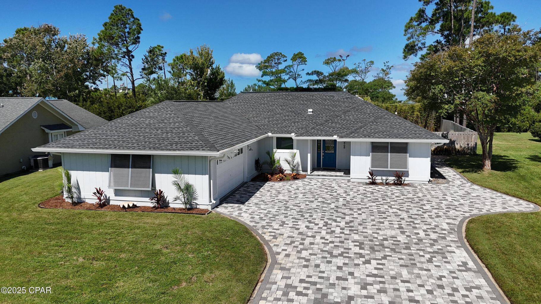 Move-in ready and waiting for you. Renovated 3BR/2BA on Wahoo Road with approx. 2,182 sq ft, paver driveway, 2-car garage, and beautifully landscaped front and back yards. Hurricane-impact replacement windows bathe the home in natural light throughout, and the guest bath features a skylight. The open living area centers on a fireplace and flows to a kitchen finished with quartz countertops throughout the home. A mudroom-style drop zone sits just off the entry, and the spacious laundry room is exactly what everyone wants for everyday convenience. The split-bedroom floor plan provides great privacy. The primary bedroom features a tray ceiling, while the ensuite bath offers double vanities, a walk-in shower, and a beautiful soaking tub, plus a walk-in closet and direct