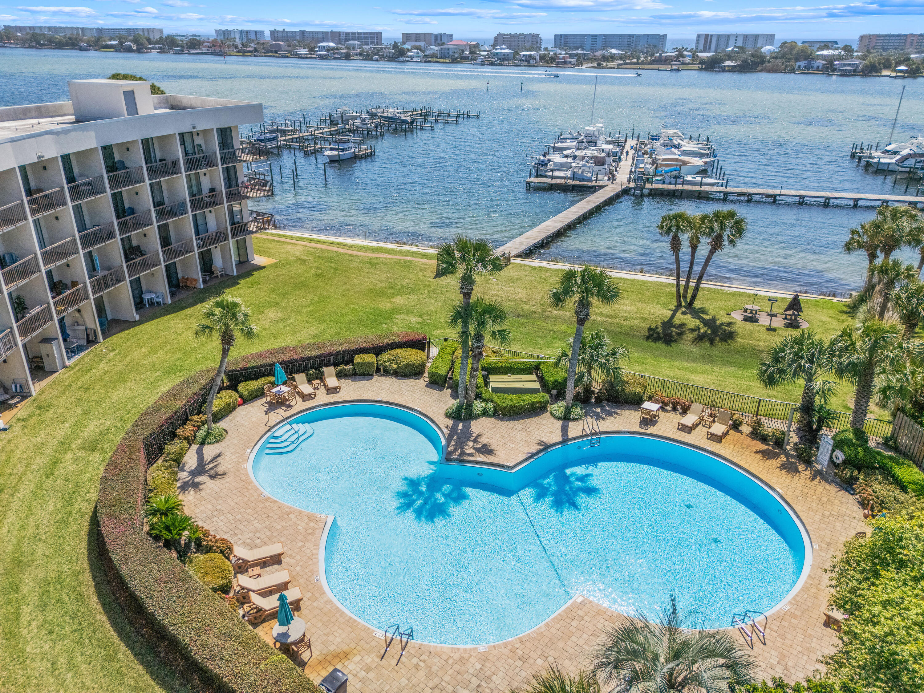 Enjoy coastal living at its finest with this beautiful fully furnished first-floor waterfront studio located at Pirates Bay Condominiums overlooking the tranquil waters of the Santa Rosa Sound in Fort Walton Beach, Florida. This charming unit offers an incredible opportunity as a vacation getaway, income-producing investment, or personal waterfront retreat. Positioned second from the end of the building, the condo sits just steps from the water and provides beautiful sound views from inside the unit, the back porch and even the front door.

Located directly along U.S. Route 98, Pirates Bay places you just minutes from the brilliant white sand beaches and emerald waters of Destin and Okaloosa Island, along with the dining, shopping, and entertainment of downtown Fort Walton Beach. The waterfront complex features several desirable amenities including a large in-ground pool, dock and waterfront access, an updated picnic area, and convenient kayak and bike storage for owners. Residents and guests can spend their days fishing from the dock, catching lunch or dinner from the sound, or simply relaxing while watching dolphins swim and play across the water.

Laundry facilities are located on each floor for added convenience, and owners are allowed to have pets. Whether you prefer to keep this coastal escape all to yourself or share it with visitors, short-term rentals are permitted, offering excellent flexibility and investment potential. Private boat slips are also available onsite for boat owners and may even be made available to renters, adding even more appeal to this waterfront opportunity.