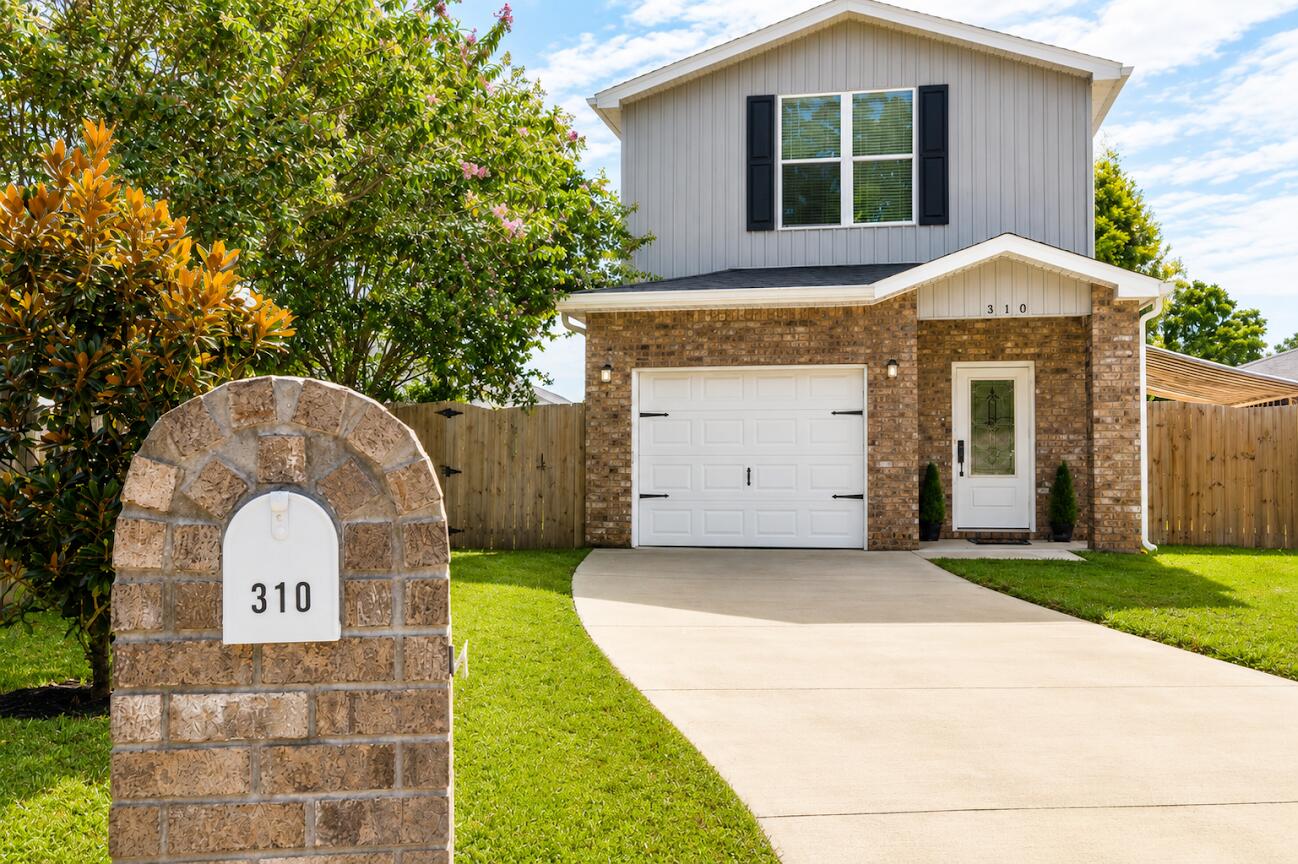 Welcome to 310 Hilburn Place, a thoughtfully designed home that blends modern construction with distinctive architectural details and custom finishes. Built in 2022, this move-in-ready residence offers 2 bedrooms, 2 bathrooms, and 1,205 square feet of well-appointed living space on an approximately 0.10-acre lot.

Inside, you'll find 9-foot ceilings, crown molding, recessed lighting, pendant lighting, and a built-in electric fireplace that serves as the centerpiece of the living area. The kitchen showcases decorative tile work, a custom backsplash, and stylish finishes that complement the home's unique character. Additional upgrades include a wrought iron staircase railing, stained glass accent window, and decorative chandelier, creating a home with personality and craftsmanship rarely found in newer construction.

The fully fenced backyard expands your living space outdoors with two covered patios, providing multiple areas to relax, entertain, or enjoy your morning coffee. A one-car garage adds convenience, while the home's 2022 construction offers the benefits of modern systems and low-maintenance living.

If you're searching for a home that offers more than standard builder finishes, 310 Hilburn Place is a must-see. Unlike many newer homes that feature standard builder-grade finishes throughout, this home has been thoughtfully enhanced with carefully selected architectural details that give it warmth, character, and a custom feel. From the moment you enter, you'll appreciate the 9-foot ceilings that create an open and airy atmosphere while crown molding adds an elegant finishing touch throughout the main living areas.

The living room is centered around a built-in electric fireplace, creating an inviting focal point for relaxing evenings or entertaining guests. Recessed lighting provides abundant illumination, while pendant lighting adds additional visual interest and warmth to the home's design.

The kitchen has been upgraded with decorative tile work and a custom backsplash that adds texture and personality while complementing the home's overall aesthetic. Every detail has been selected with care, creating a space that is both functional and visually appealing.

Additional architectural features continue throughout the home, including a wrought iron staircase railing that adds timeless style, a stained glass accent window that provides unique character and natural light, and decorative lighting fixtures, including a chandelier that further distinguishes this home from typical new construction.

The primary and secondary bedrooms are comfortably sized and designed to maximize functionality while maintaining a warm and inviting atmosphere.

Outdoor living is equally impressive. The fully fenced backyard provides privacy while offering multiple spaces to enjoy the outdoors. One covered patio is ideal for everyday outdoor living, while a second covered patio creates additional flexibility for entertaining, grilling, dining, or simply relaxing. The backyard offers ample lawn space while remaining easy to maintain.

Additional features include:

Built in 2022
Approximately 1,205 square feet of heated and cooled living area
One-car garage
Approximately 0.10-acre lot
Fully fenced backyard
Two covered patios
9-foot ceilings
Crown molding
Built-in electric fireplace
Decorative tile work
Custom kitchen backsplash
Recessed lighting
Pendant lighting
Decorative chandelier
Wrought iron staircase railing
Stained glass accent window
Modern construction with contemporary systems
Conveniently located in Pensacola, this home offers easy access to shopping, dining, schools, medical facilities, and major transportation routes while providing a move-in-ready opportunity with thoughtful upgrades rarely found in homes of similar size and age.