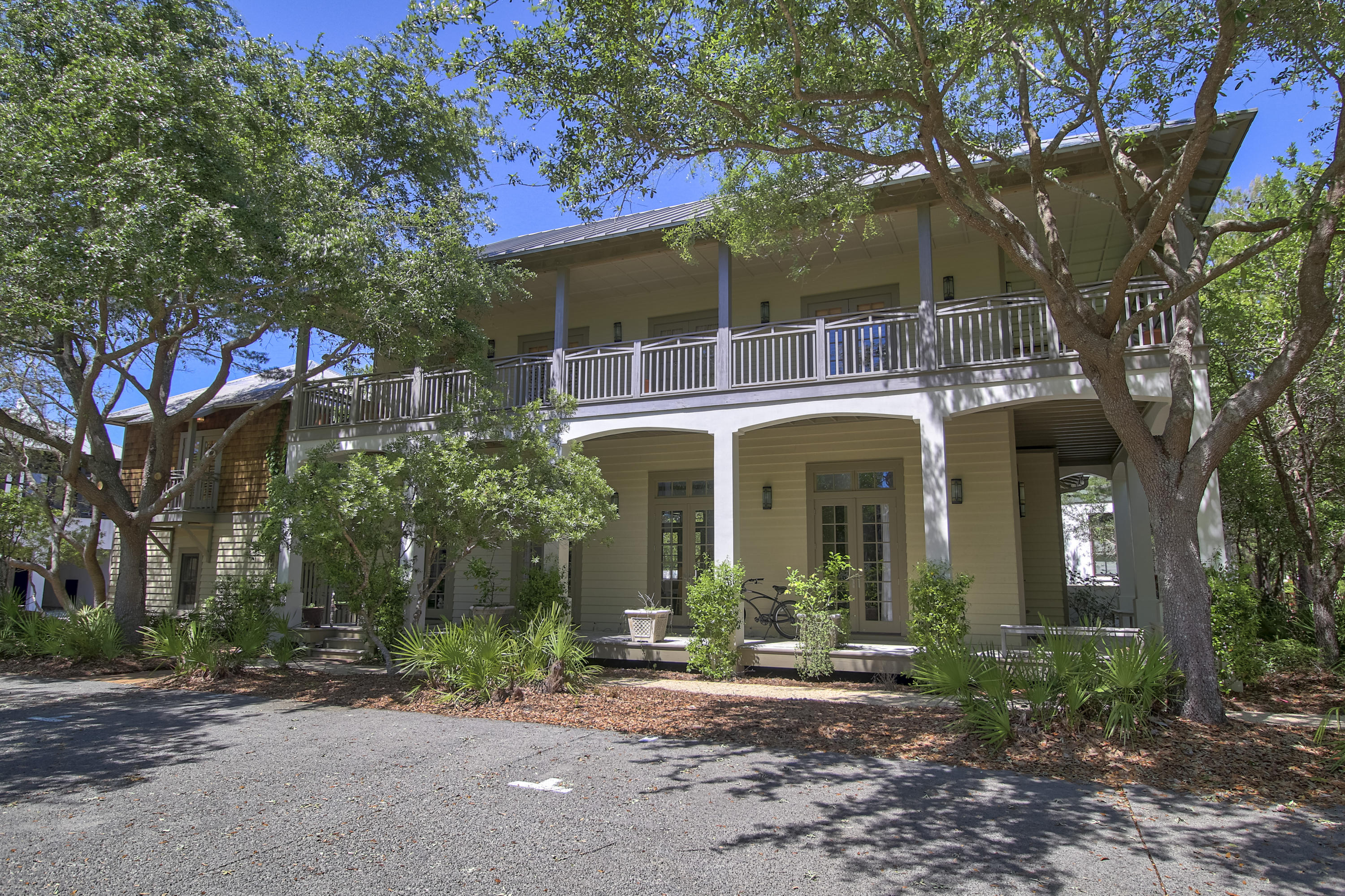 Thoughtfully designed for both relaxed living and effortless entertaining, this beach retreat features a seamless open floor plan that extends to a private courtyard. Outdoor amenities include a heated pool, summer kitchen, fire pit, brick pizza oven, and a tranquil garden setting--creating an exceptional space for year-round outdoor living.

The first floor offers an open living, dining, and kitchen area, along with a well-appointed primary suite. Upstairs, three guest bedrooms each include private baths, complemented by a secondary gathering area and media room.

Expansive wraparound porches on both levels provide multiple spaces to unwind and take in the peaceful boardwalk setting. A two-car garage and carriage house add flexibility and functionality to this well-rounded property. The carriage house is a fully functioning apartment with a separate bedroom, full bath, darling kitchen, cozy and spacious living space, and a private courtyard.