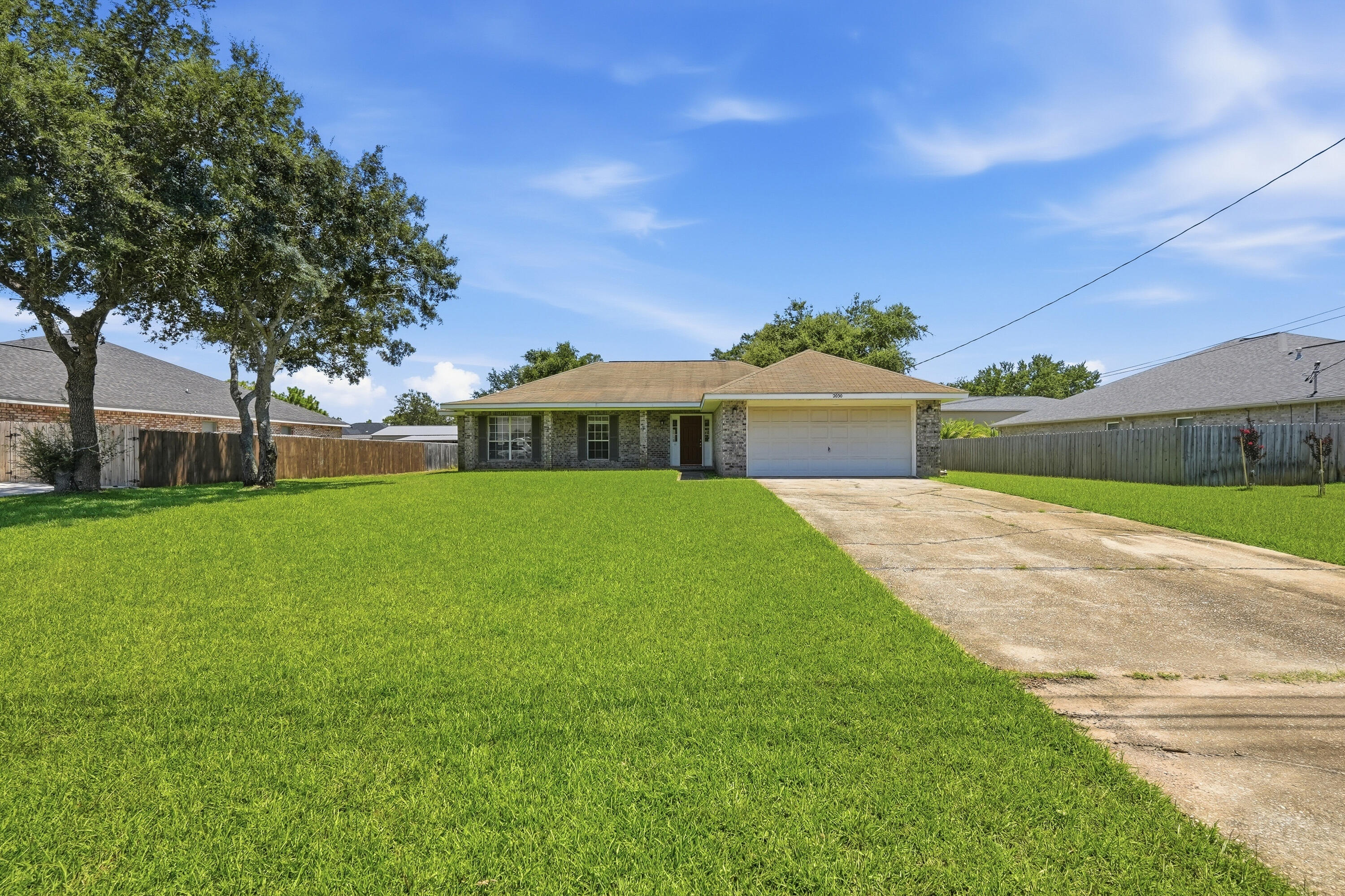 Welcome to this spacious and beautifully maintained 4-bedroom, 2-bathroom home nestled on almost half an acre in one of Navarre's most highly sought-after neighborhoods! The inviting large front porch welcomes you into a thoughtfully designed split-bedroom floor plan offering comfort, privacy, and plenty of space.

The open eat-in kitchen provides a great gathering space for everyday meals and entertaining, while new luxury vinyl plank flooring and carpet add a fresh, modern feel throughout the home. The spacious primary suite offers a relaxing retreat with a garden tub, separate walk-in shower, and large vanity with dual sinks.

The fourth bedroom is versatile and makes an excellent home office, study, or flex space to suit your needs. Outside, enjoy the expansive lot with plenty of room for outdoor activities, entertaining, or simply relaxing in your own private space.

As a resident, you'll also have access to an impressive array of Holley by the Sea community amenities. This desirable Navarre location offers the perfect combination of space, comfort, and access to resort-style amenities. Don't miss the opportunity to make this wonderful home yours--schedule your showing today! Pets considered with application.