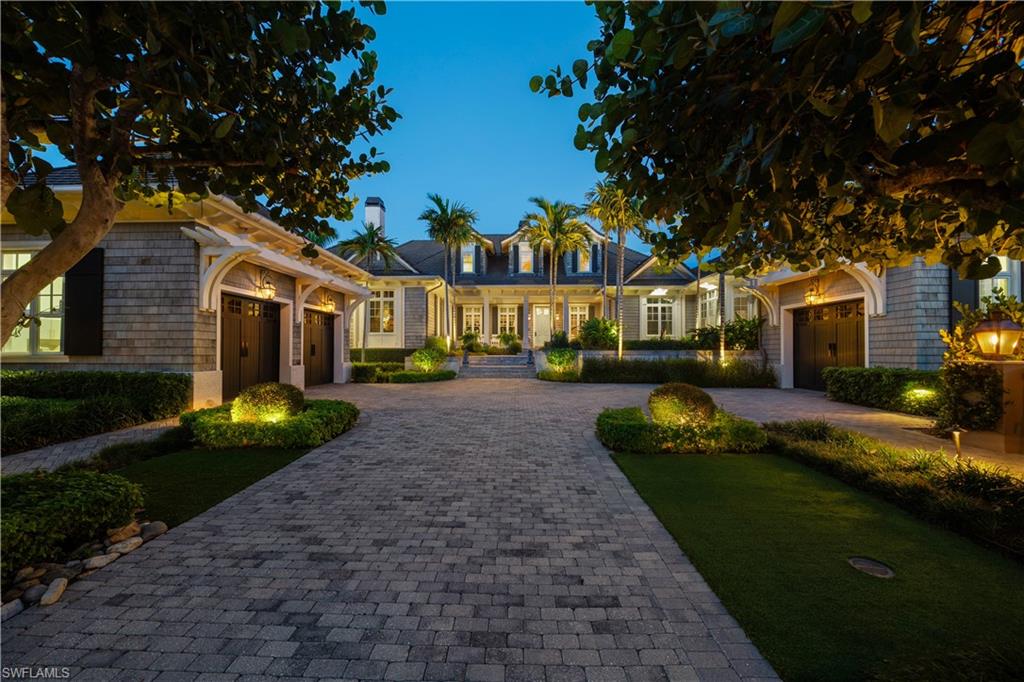 Quietly situated at the southernmost end of Gulf Shore Boulevard South, directly across from beach access, this exceptional Olde Naples estate is a true crown jewel, spanning more than one-half acre. Designed by John Cooney of Stofft Cooney Architects and meticulously refurbished throughout, the residence reflects uncompromising craftsmanship and timeless sophistication and can be acquired turnkey furnished for immediate occupancy. From the moment of arrival, the home makes a lasting impression. Flickering gas lanterns, a gracious front porch, and classic symmetrical architecture accented by exquisite millwork create an inviting sense of elegance. Inside, refined finishes abound, including mahogany front doors, rift-sawn white oak flooring, and a striking vaulted ceiling detail upon entry. The living room’s balanced symmetry and detailed millwork flow seamlessly into the gourmet kitchen and dining area, anchored by a 60" Wolf dual-fuel range featuring six burners, an infrared charbroiler, and an infrared griddle. Additional highlights include a Sub-Zero side-by-side refrigerator and freezer, integrated refrigerator drawer systems, and two Miele dishwashers—perfectly suited for both everyday living and entertaining. Thoughtfully curated spaces throughout the home include a bespoke media room with soundproofed walls and a Savant sound system, a handsome study with custom built-in display cabinetry overlooking the pool, a fully reimagined bar and library, and a dedicated fitness studio complete with a steam shower—each space designed for both function and refined living. The estate is comprised of five well-appointed bedrooms, four of which feature en-suite baths, offering refined accommodations for both residents and guests alike. The Master Suite and Bath offer a true private retreat, enveloping you in comfort from head to toe. A tranquil sitting area overlooks the spa and pool, providing a serene backdrop for rest and reflection. Crown moldings and elegant casings throughout enhance the sense of refined craftsmanship, creating a space that feels like a peaceful escape—while remaining unmistakably at home. Following a complete renovation inside and out, the outdoor living spaces are equally compelling. An expansive, oversized porch is designed for rest and relaxation, offering an exceptional poolside setting framed by a preserved Wild Oak tree—an enchanting natural centerpiece that enhances the estate’s sense of serenity and timeless charm. Additional elevated improvements include two side-mounted car lifts, whole-house generator, dual dehumidification systems, a steam shower within the fitness studio underscoring the home’s exceptional level of care, resilience, and thoughtful investment.