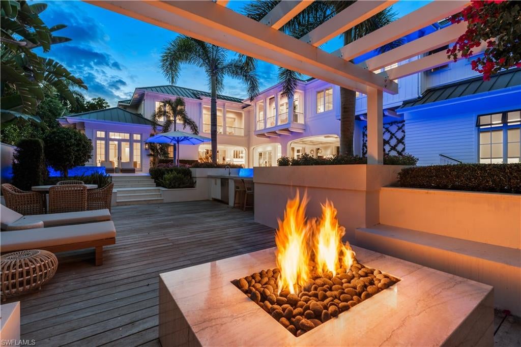 Without question the best value in this segment of the marketplace. Fantastic opportunity to acquire this MHK Architecture designed, stunning home built by VIV. Situated on an oversized 100’ x 185’ homesite on iconic Gordon Drive, ideally close to Naples’ white-sand beaches and 3rd Street South. This 2023 coastal contemporary estate offers 7,486 square feet of air-conditioned living space with 5 bedrooms + study, 6 full and 2 half baths, upper lounge, VIP living area, and glass-enclosed exercise room. Exceptional finishes include Legno Bastone wide-plank flooring, Poliform closets, natural stone accents, designer fireplace, Lutron HomeWorks lighting and shade control, Sonos audio, elevator, and two laundries. Gourmet kitchen and separate service kitchen feature elite appliances, gas cooking, double ovens, steam oven, and built-in ice maker. Additional features include air-conditioned 4.5-car garage with EV charging, whole-house generator, impact-rated doors and windows, and full concrete construction. Expansive outdoor living area showcases a 65’ resort-style pool with swim-up bar, gas-heated spa, outdoor kitchen with island, fireplace, fire pit, and automated roll-down screens and shutters. Offered furnished, built for the ultimate luxury lifestyle and ready to enjoy immediately.