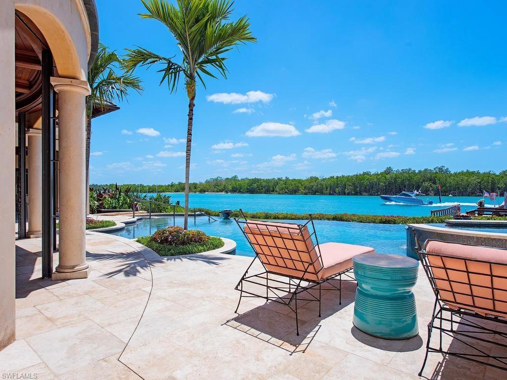 This custom waterfront residence boasts 194 ft. of water frontage on Admiralty Bay, in PortRoyal, offering full southern exposure and sweeping views with direct Gulf access. Unique architectural features include Venetian plaster, wood and stone floors, custom hand-made railings, and an iron elevator. The chef's kitchen is a culinary dream with three islands, barrel-vaulted brick ceilings, and commercial refrigerators. Seamless indoor-outdoor living is anchored by an infinity-edge pool and spa, complemented by a full outdoor kitchen featuring a stone fireplace and pizza oven.

The primary suite serves as a true owner's retreat with a sitting room, private balcony, and a luxurious spa bath finished in honey onyx that includes a steam shower with chromotherapy. Additional highlights include a private dock with lift, wine cellar, multiple fireplaces, and the anticipation of the spectacular new $100M clubhouse set to be completed in late 2026.

- 194 ft. of water frontage on Admiralty Bay
- Chef's kitchen with three islands and commercial appliances
- Infinity-edge pool and outdoor kitchen with pizza oven
- Private dock with lift for easy Gulf access
- Luxurious primary suite featuring honey onyx spa bath
- Wine cellar for connoisseurs
- Offered Decorator Furnished
- Upcoming $100M clubhouse completion in late 2026
- Immediate Port Royal Club eligibility