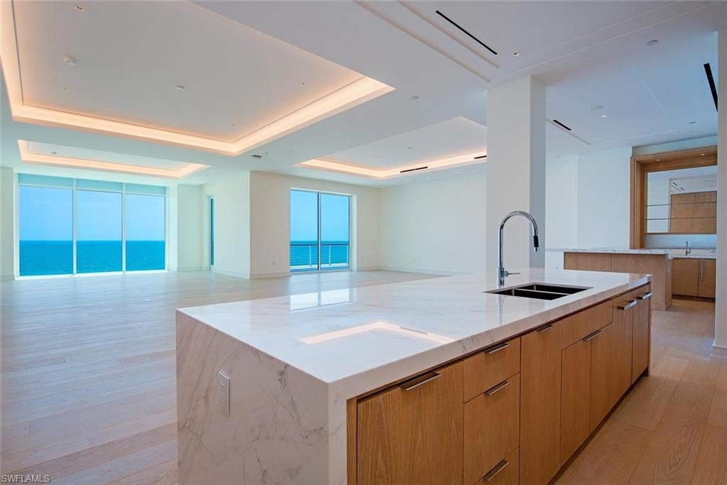 Experience unparalleled beachfront living at the newly completed Four Seasons Residences at the storied Naples Beach Club. Originally opened in 1946 by the Watkins family, this historic piece of the Paradise Coast has been reimagined as Florida's most anticipated luxury beachfront address. This exceptional four bedroom, four and a ½ bath residence is designed with the scale and comfort of a private estate, featuring 12-foot ceilings, light-filled interiors, a spacious west-facing corner terrace, and breathtaking Gulf views. A contemporary Beachwood palette showcases white oak cabinetry and doors throughout, complemented by Volakas marble kitchen countertops and backsplash, washed white oak flooring, Bianco Dolomiti marble in the primary and junior primary baths, and Vanilla Ice marble in the secondary baths. Impeccably designed by Champalimaud, the home features premium appliances, custom cabinetry, dual primary baths, expansive walk-in closets, seamless indoor-outdoor living, and two private entrances, including a direct elevator from the lobby. Four Seasons Residences at Naples Beach Club is an exclusive collection of just 58 beachfront homes offering 1,000 feet of pristine beach, championship 18-hole golf, a world-class spa, six dining venues, Hamilton Harbour Yacht Club access, and the legendary Four Seasons 24-hour concierge and personalized services.