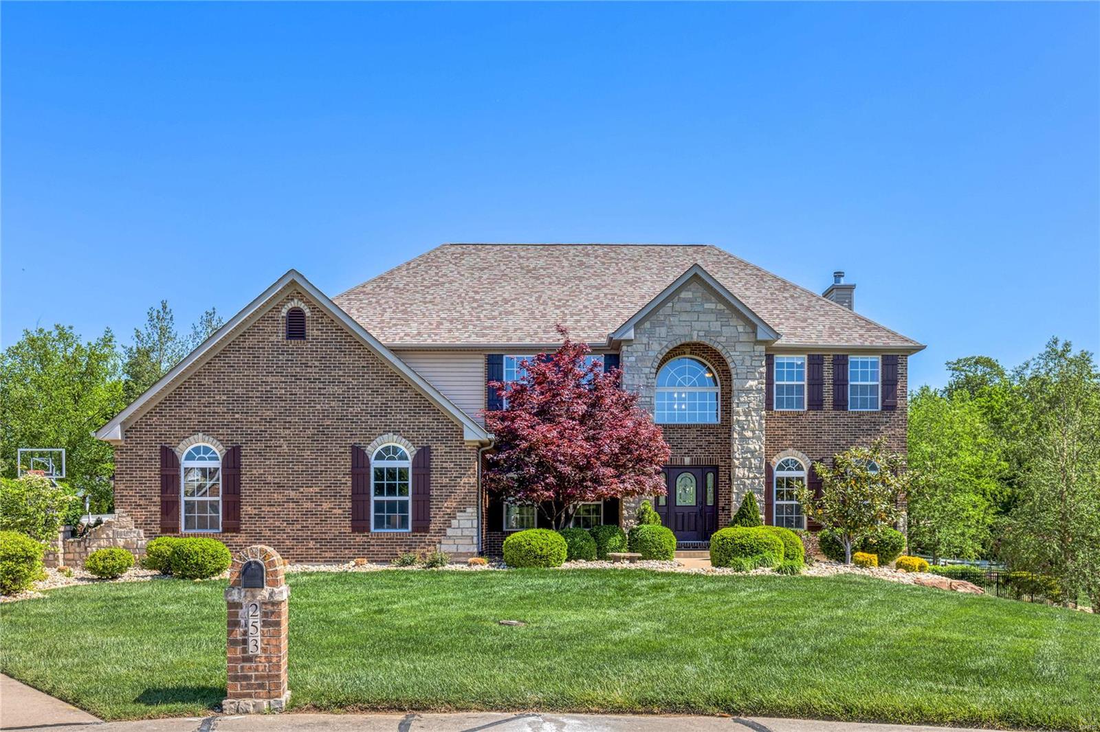 Welcome to your dream home, with 5200 sq ft total living space, in highly sought after Cottleville. This custom built, 5 bedroom, 4.5 bath home is nestled on a gorgeous 1 acre lot . An inviting two-story entry opens to a large formal dining room with trayed ceilings and a living room with custom bookshelves and French doors. The spacious eat-in kitchen has an oversized center island, 42" cabinetry, granite countertops, stainless steel appliances and large walk-in pantry. Upstairs the large primary suite offers coffered ceilings, a custom 12x13 walk-in closet with center island, and en suite bath. Bonus room with custom bookshelves and three spacious bedrooms each with walk-in closets complete the upstairs.  2 bedrooms share a Jack-and-Jill bath. The finished walk-out lower level is perfect for your entertaining needs. You will find a full custom bar, work-out room, 5th bedroom and 4th bath. Escape to the privacy of the picturesque backyard and enjoy the custom designed salt water pool.