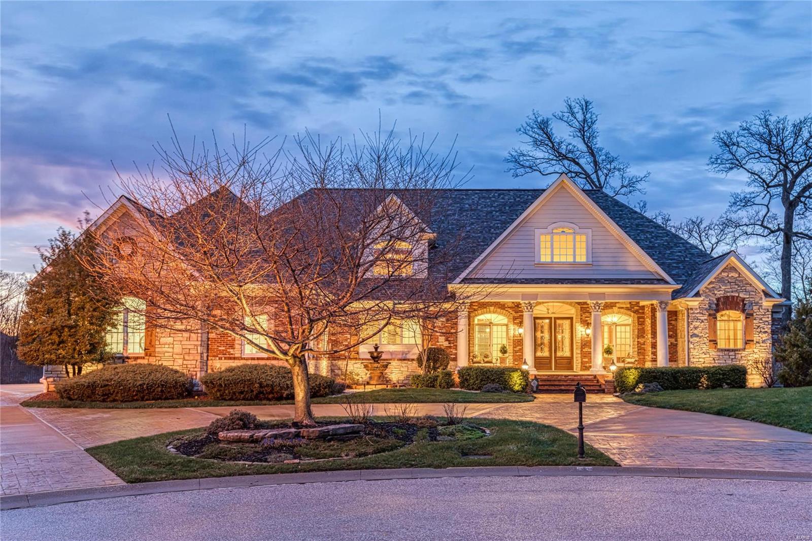 Spectacular waterfront property in premier gated neighborhood! This Fischer & Frichtel-built Estate home features over 9300 sf of living space enhanced by distinctive architectural elements & integrated security & sound systems. Impressive foyer opens to private office, elegant dining room & stunning great room with cast stone fireplace & expansive windows that overlook 4-ac lake. Designer kitchen featuring cherry cabinetry, granite countertops, commercial grade appliances & butler’s pantry adjoins light-filled breakfast room & vaulted hearth room highlighted by floor-to-ceiling stone fireplace. Coffered master bedroom suite offers a relaxing retreat with fireplace, bay window & beautifully appointed bath with shower spa. The 2nd floor extends the living quarters with 2 additional ensuite bedrooms & bonus room. Lower Level includes family room, kitchen & media room plus 2 ensuite bedrooms, 2nd laundry, safe room & ½ bath. Situated on a 2.15-ac lot with pool, deck, patio & 4-car garage. Additional Rooms: Mud Room