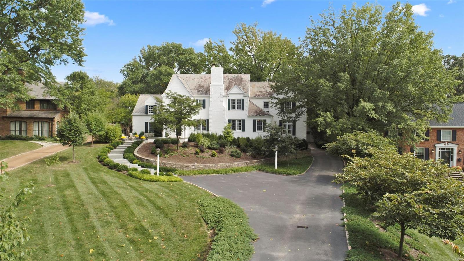 Exclusive updated offering in prestigious Fair Oaks.  Stately painted brick home with gorgeous slate roof and professionally landscaped.  5 beds and 4.5 baths make this home perfect for any family.  Hardwood flooring adorns most of the main level. Family room with gas fireplace flows into the rich, wood paneled office shuttered by French doors.  Formal dining area is flooded with light and provides access to the large terrace. Kitchen has large center island, 2 sinks and gorgeous wood cabinetry.  Spanish tile great room has wet bar, coffee station and wood burning fireplace.  The master suite has a completely new bath with radiant floors, his and her vanities, 2 person shower all set in decorative white marble.  Water closet has state of the art Toto commode.  4 spacious beds share 2 secondary full baths.   Finished lower level features open playroom, music room, full bath and storage.  Main floor laundry has custom built lockers. 2 two-car garages. Additional Rooms: Mud Room